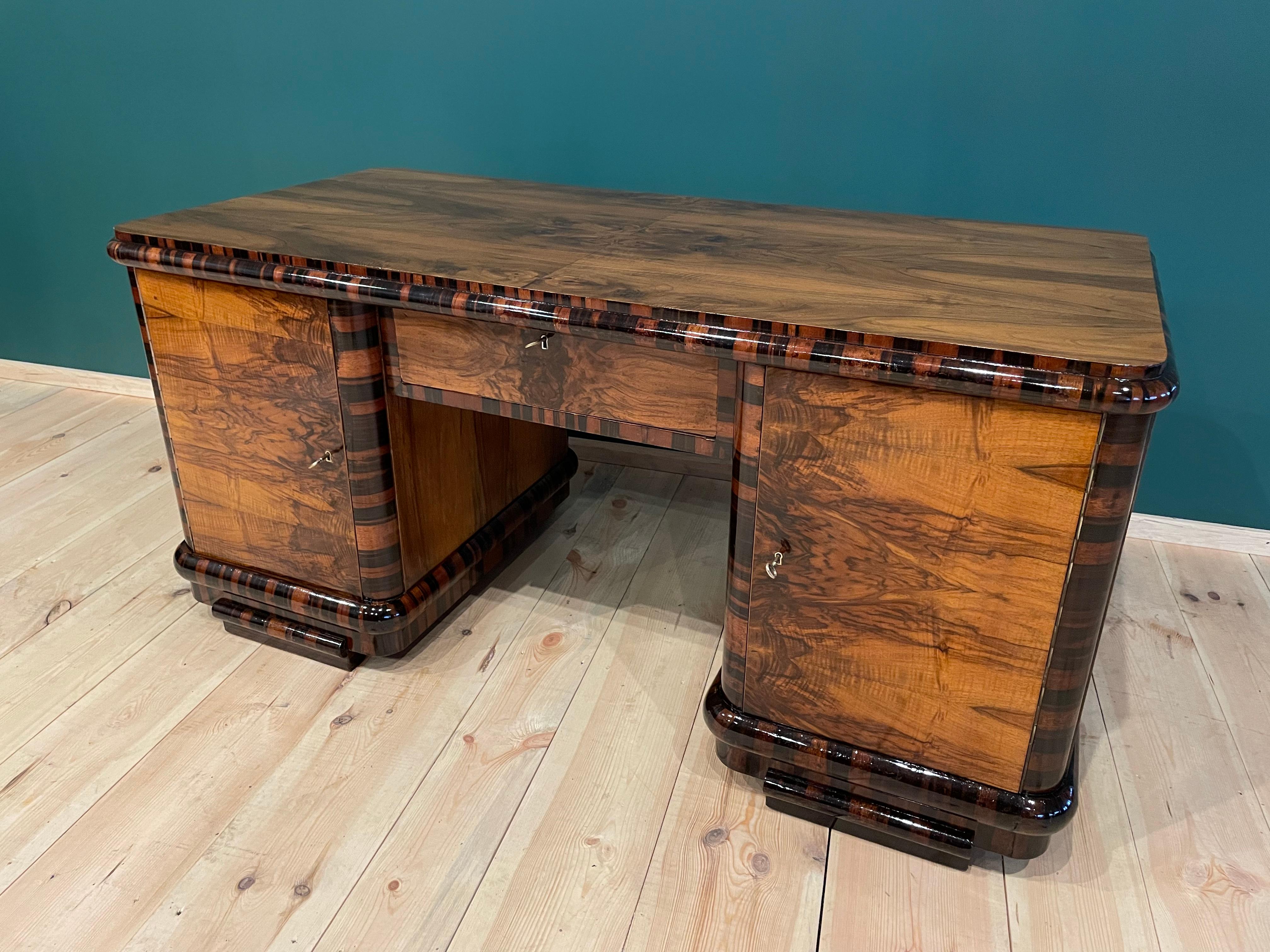 We present Art Deco desk from 1940.

Every piece of furniture that leaves our workshop from the beginning to the end is subjected to manual renovation, so as to restore its original condition from many years ago
(It has been cleaned to bare