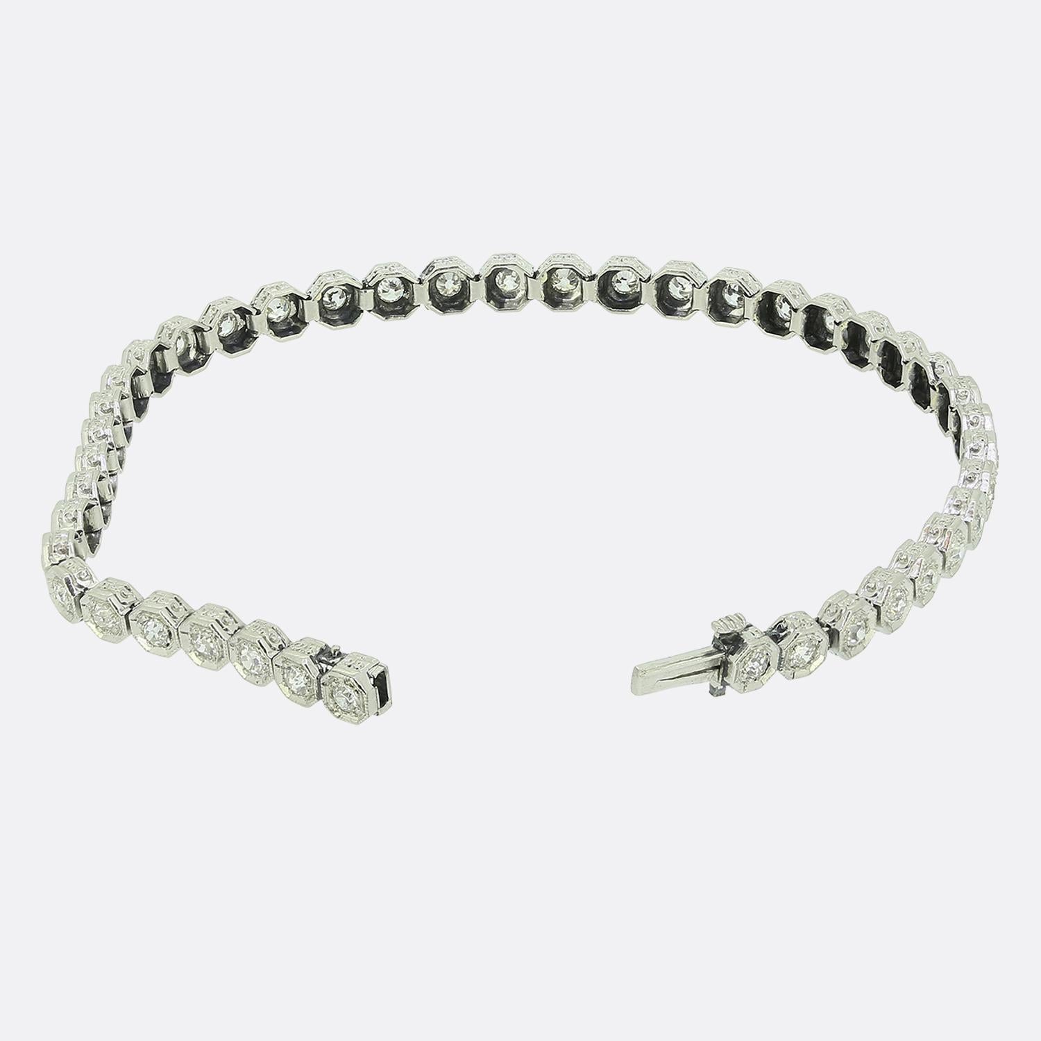 Here we have an exquisite diamond bracelet taken from the early stages of the Art Deco movement. Crafted in platinum, this piece features a series of white old mine cut diamonds, each set in a distinctive octagonal bezel. The bracelet's design