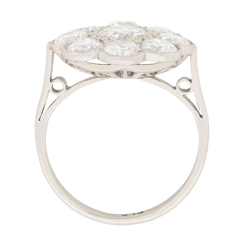 This stunning cluster ring dates back to the 1920s, or 1930s and is wonderfully art deco in design. The centre stone is 0.70 carat and is a beautiful old cut. It has been estimated as an F in colour and VS2 in clarity. It is expertly rub over set