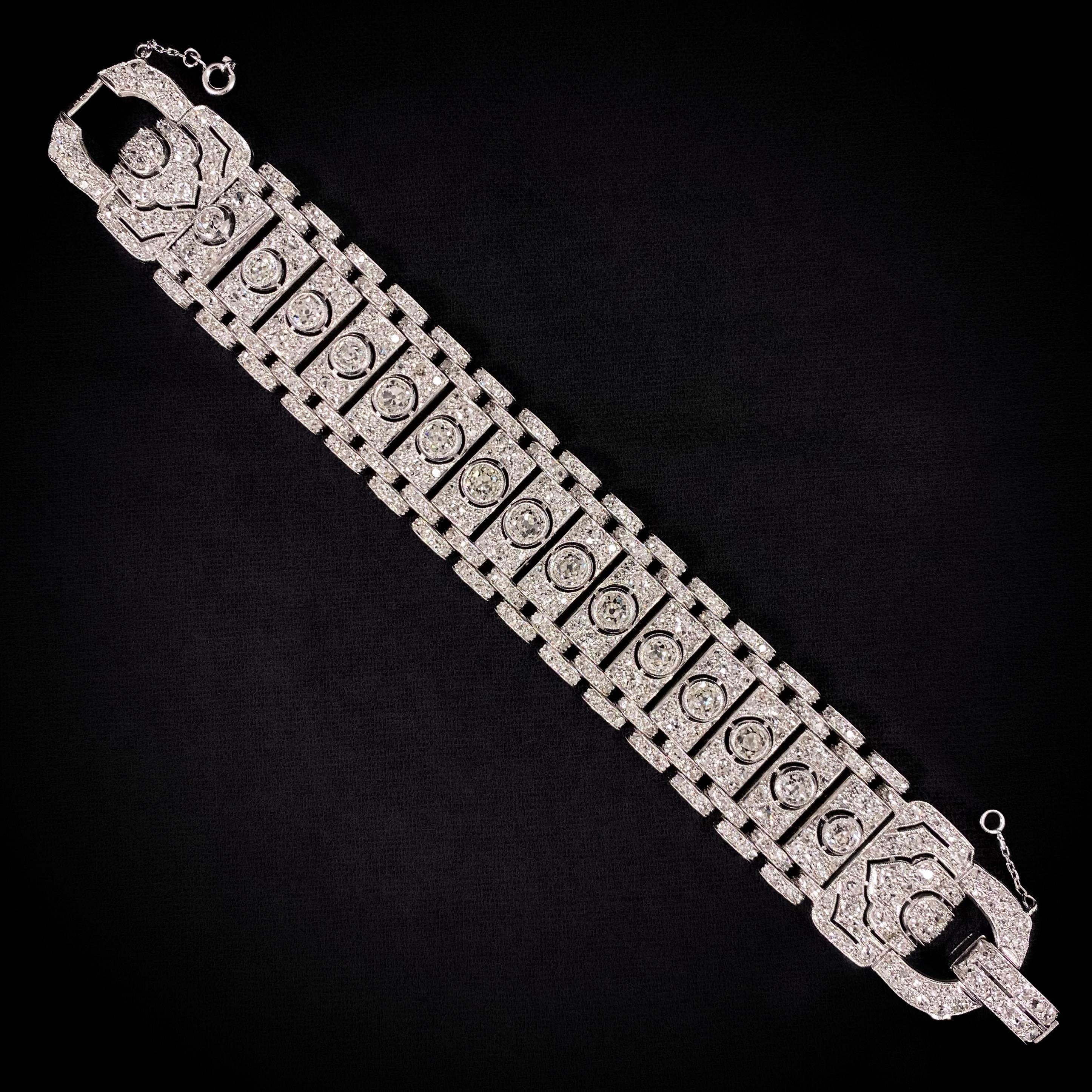 A breathtaking 21-Carat Art Deco diamond geometric buckle tank bracelet in platinum and white gold, French, 1930s. This jewel is composed of a sequence of pave-set diamond plaques accented to the center with a large old brilliant-cut diamond,