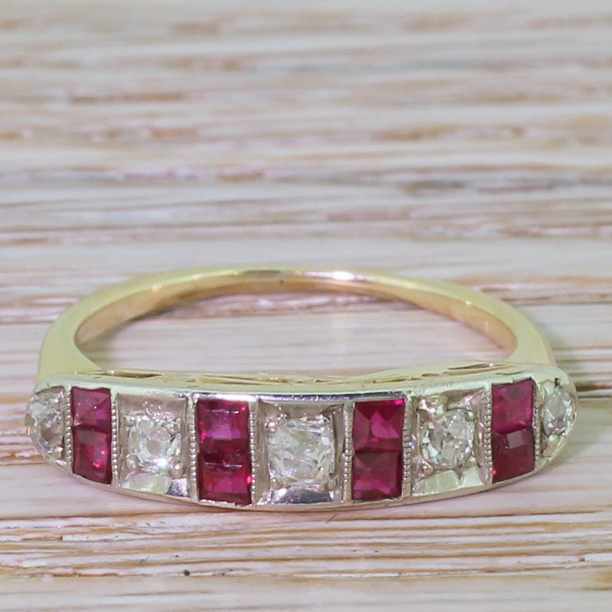 A fine and exceptionally wearable half hoop ring. The five old mine cut diamonds, of graduating size, are mounted in milgrained box settings with pairs of step-cut rubies. The stones are secured in white gold with a lovely, understated work in the