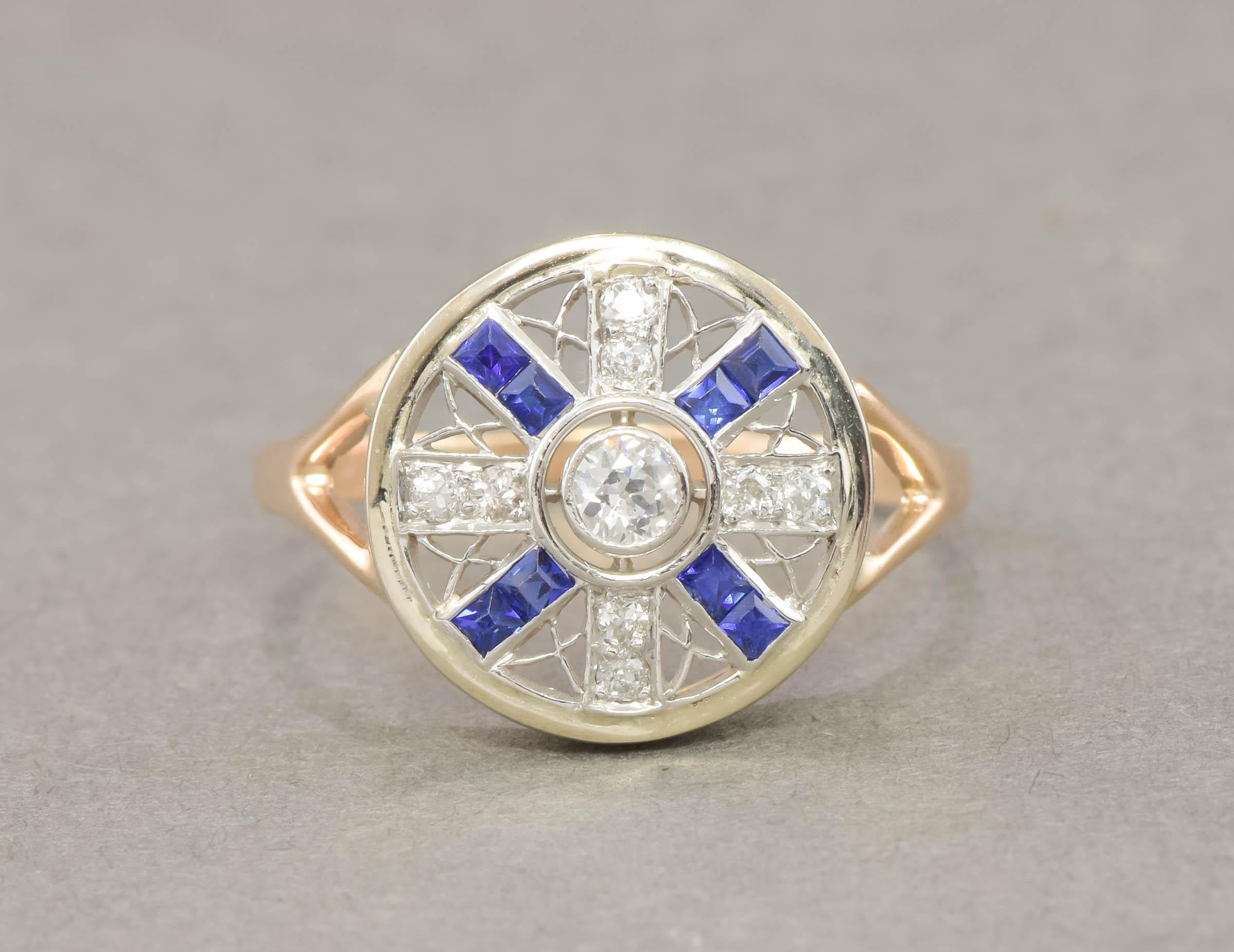 Dating to the Art Deco period, this old cut diamond and synthetic sapphire ring has a fantastic design and very striking presence on the hand.

Crafted of platinum & 14K yellow and white gold, the ring features a striking filigree geometric design