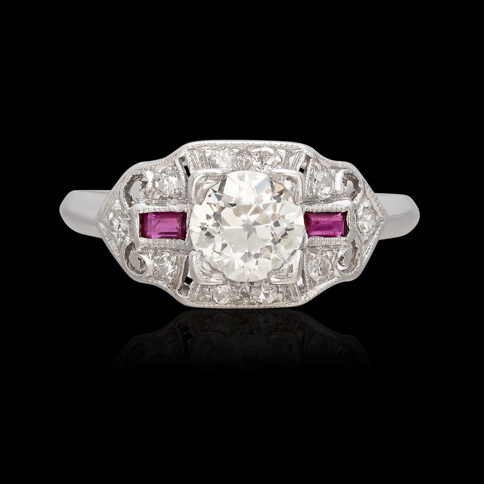 Looking for a pop of color in your antique diamond engagement ring? Look no further! This platinum beauty features a 0.65 carat Old European Cut Diamond (+- K/VS) set with four prongs amidst .10 carats of fine melee diamonds and baguette rubies on