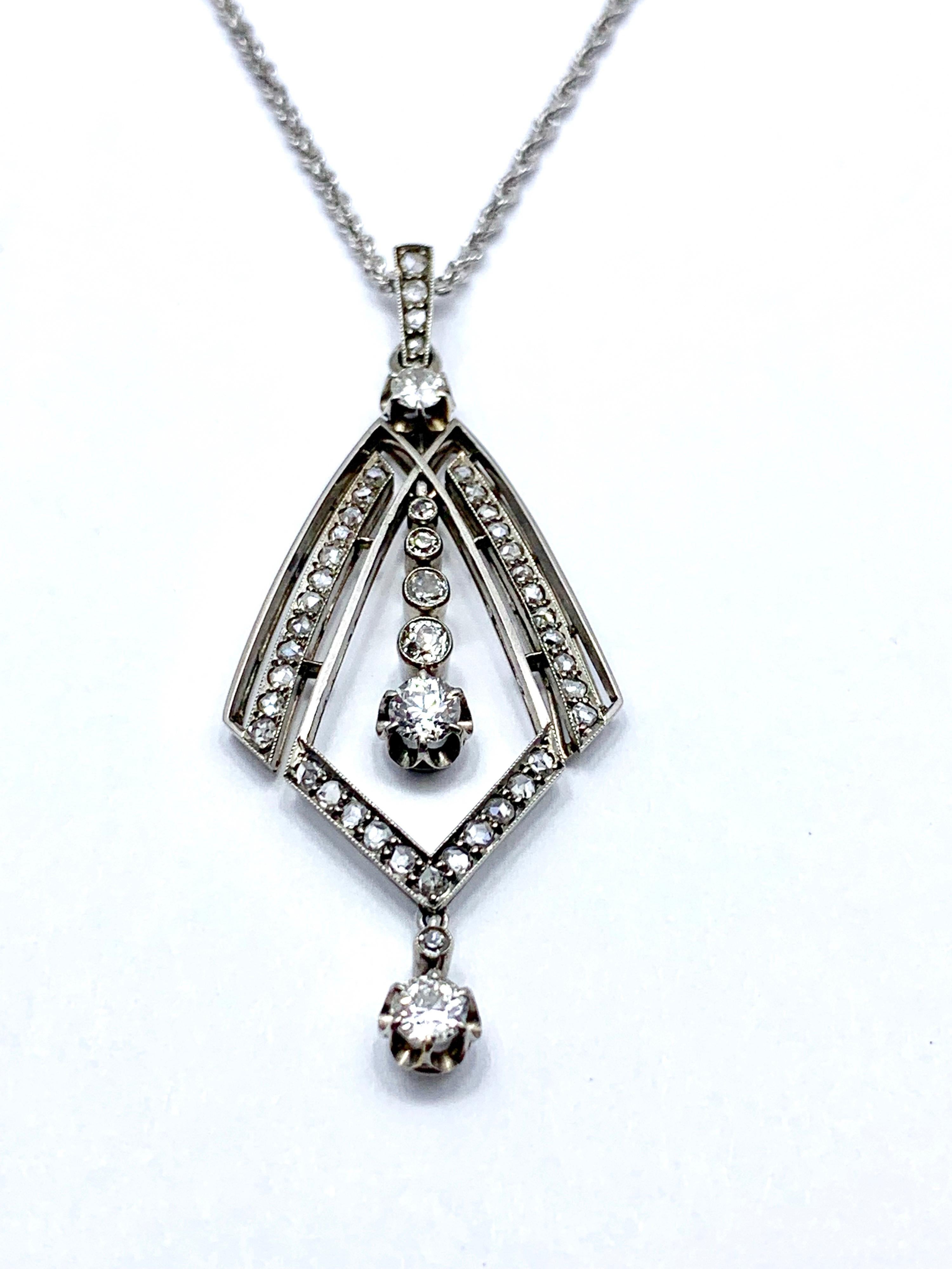 An absolutely stunning Art Deco Old European and rose cut Diamond pendant set in white gold.  The pendant is a geometric design, handcrafted in the 1920's.  The movement from the center and bottom Diamond suspensions allow for light to hit from many