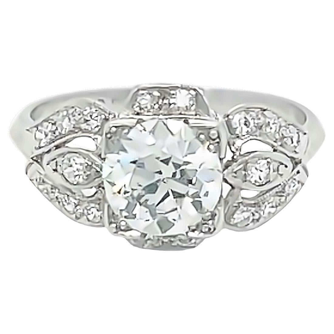 This stunning vintage art deco era engagement ring is crafted in platinum and features a dazzling old European diamond center, estimated to be 0.85 carat., G color and VS clarity. The center diamond is set in a four-prong head and accented by