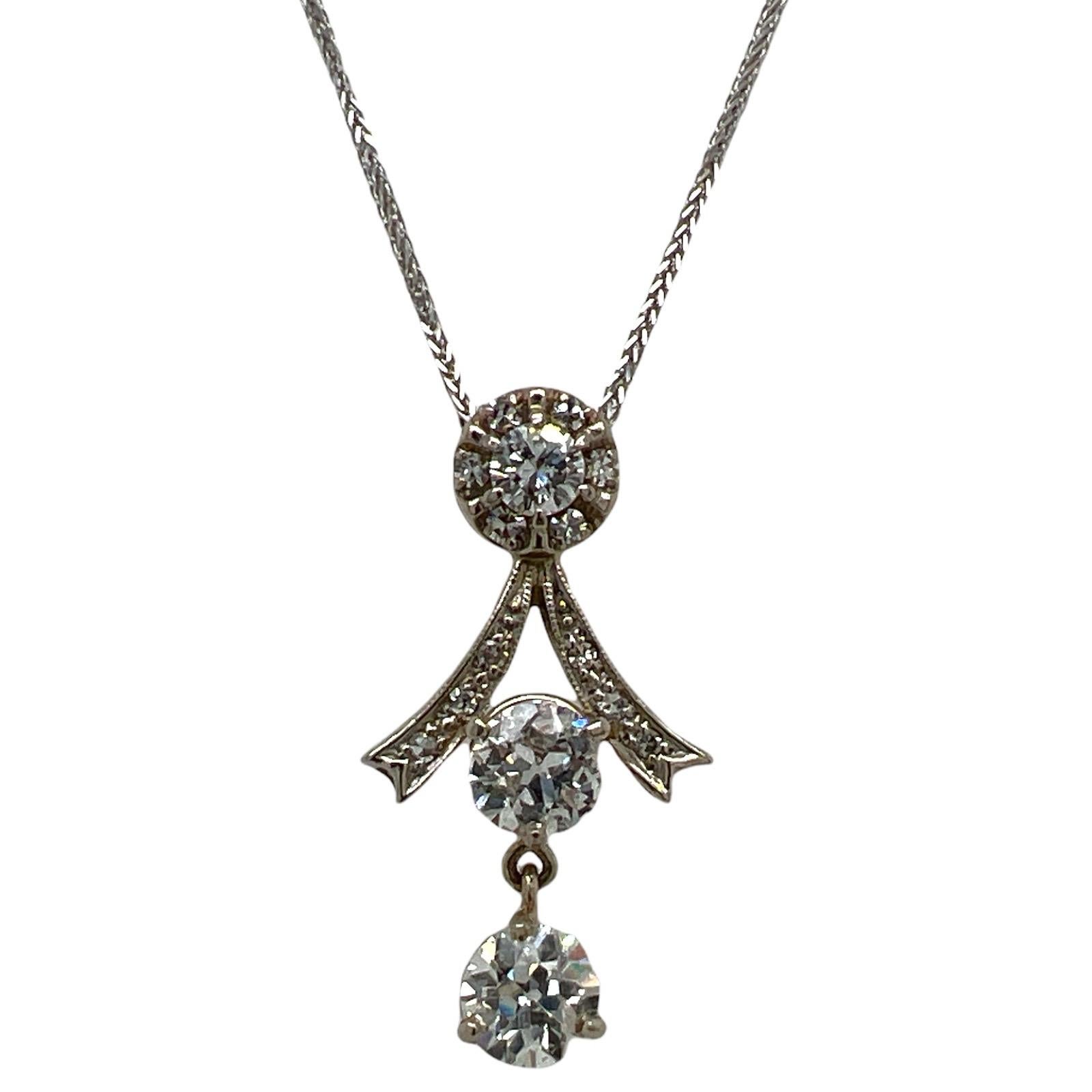 Art Deco diamond drop pendant fashioned in 14 karat white gold. The pendant features 2 Old European cut diamonds weighing approximately 1.64 carat total weight, and another .42 cttw side diamonds (2.06 CTW). The pendant measures 1.5 inches in length