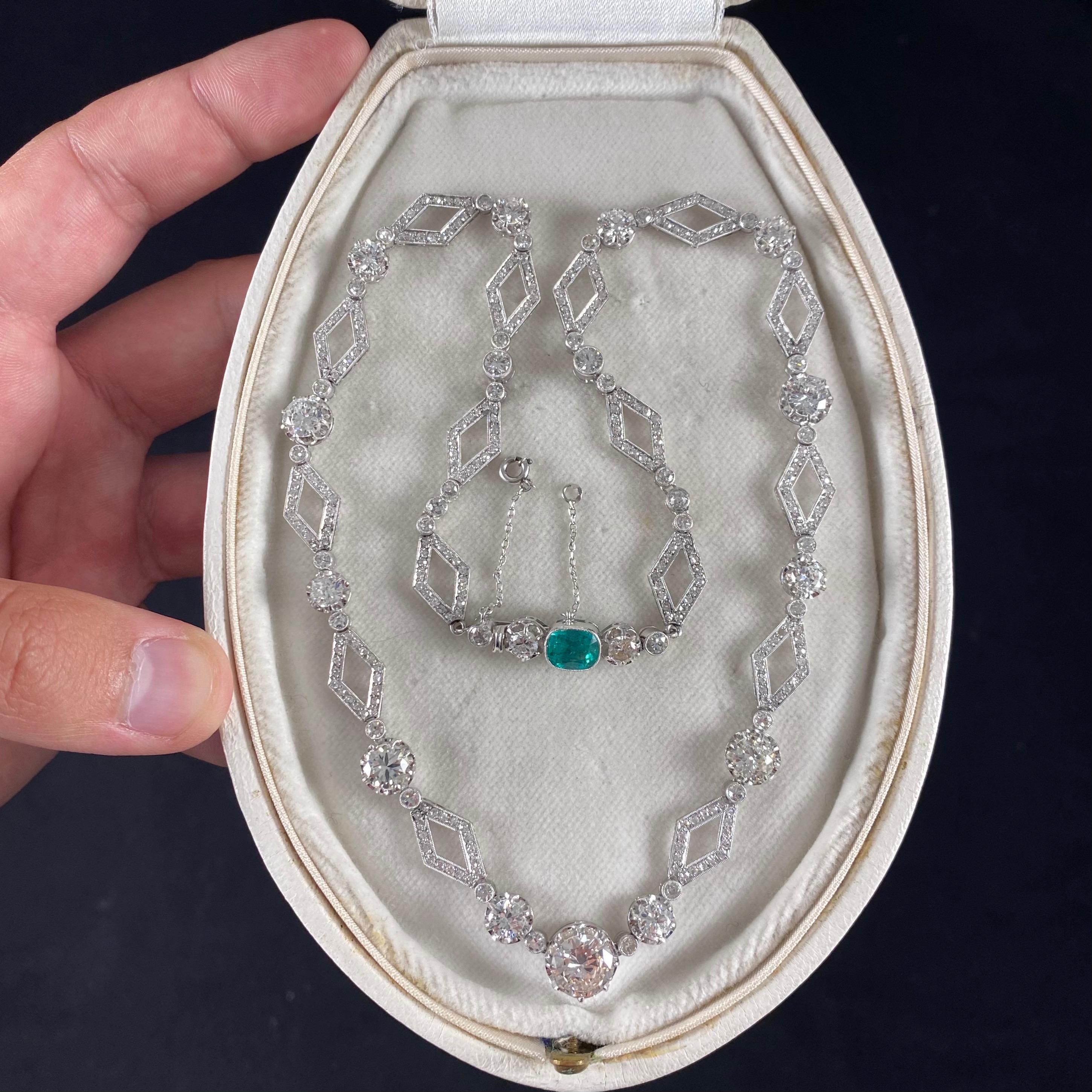 A sophisticated Art Deco diamond and emerald geometric link necklace in platinum and white gold, 1930s. This ravishing jewel is designed as a sequence of 53 individually-set Old European brilliant-cut, Transitional round brilliant-cut and old