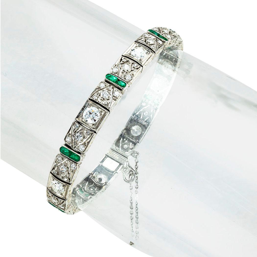 Art Deco old European-cut diamonds and emeralds platinum line bracelet circa 1925. 

ABOUT THIS ITEM:  #B-DJ113K. Scroll down for specifications.  The bracelet design is like a lovely tapestry of diamonds accentuated at intervals with bullet-shaped,