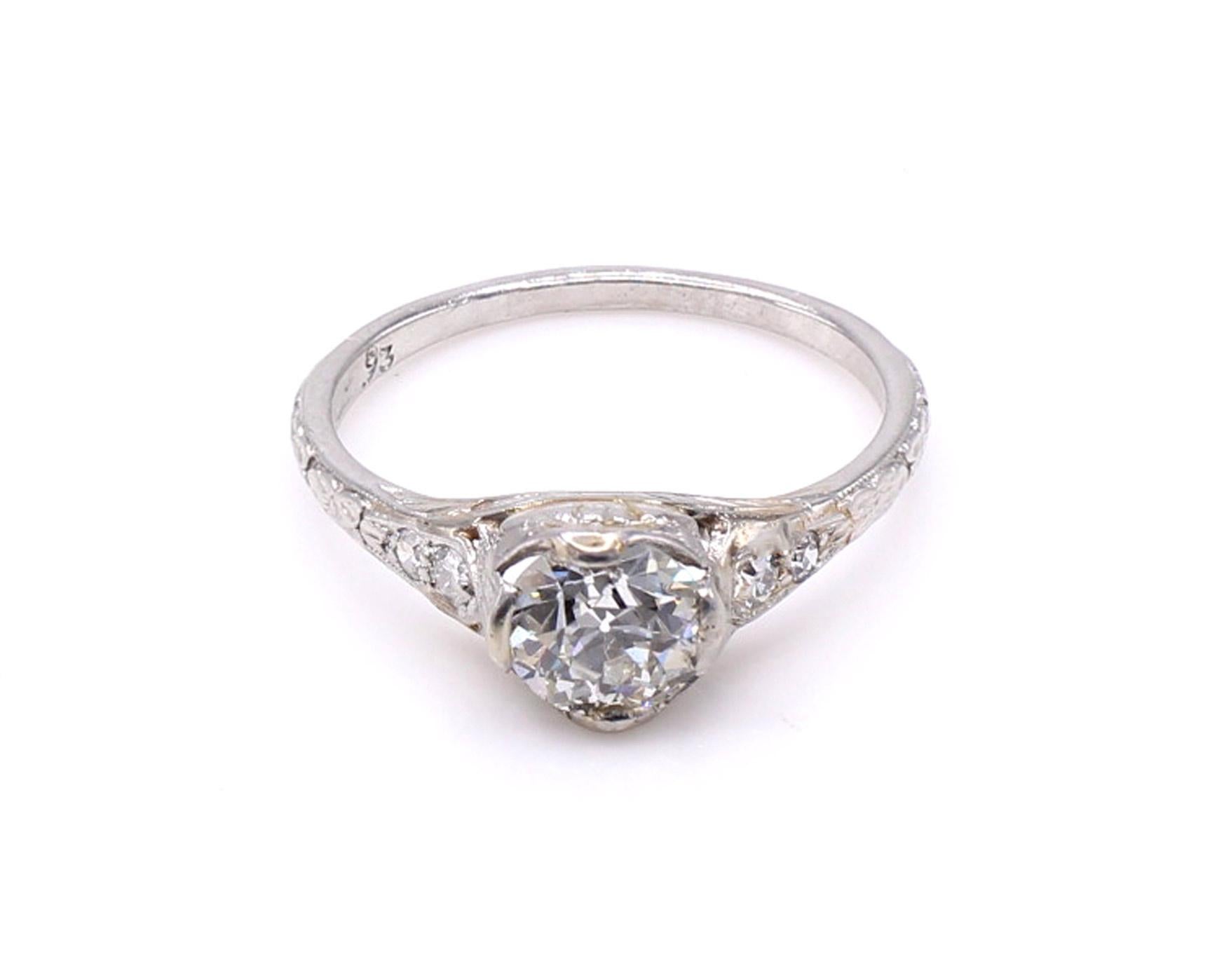 Beautifully designed and masterfully hand-crafted in platinum this Art Deco diamond engagement ring is both charming and unique. Set with an perfectly cut Old European Cut diamond, the wide faceting, high crown and small table give this diamond its