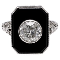 Bague filigrane Art déco, diamant taille européenne ancienne, onyx et or blanc 18 carats