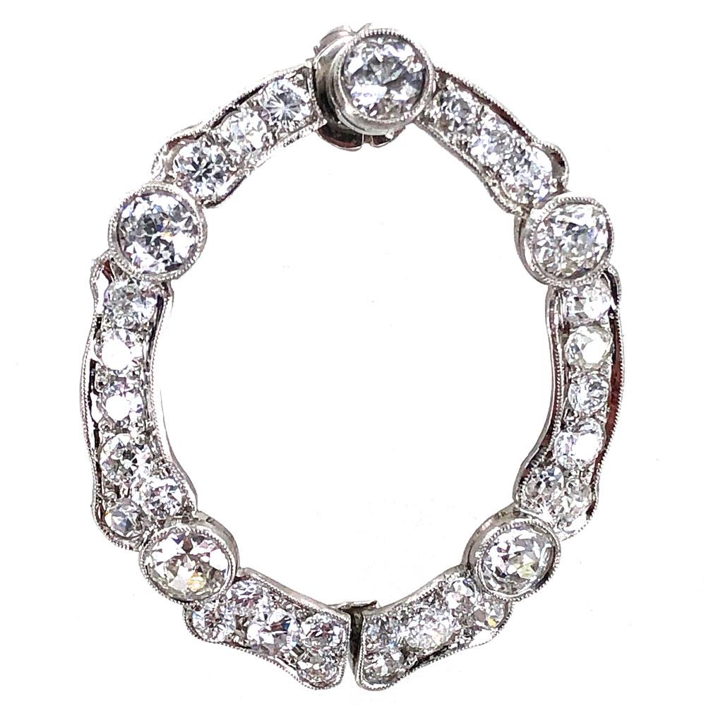 Stunning Art Deco open hoop earrings crafted in platinum. The earrings feature 6.20 carat total weight Old European Cut diamonds graded G-H color and VS clarity. The hoops measure 1.25 inches in length and 1.00 inch in width. 