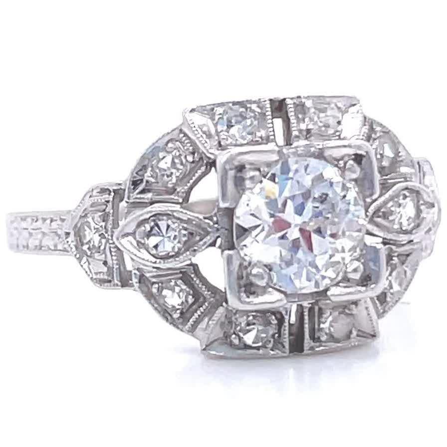 You will love this charming engagement ring with lots of history. It is made for you if you appreciate treasures from the past featuring symmetry and delicacy in the best Art Deco traditions. This Art Deco Diamond Platinum Engagement Ring features