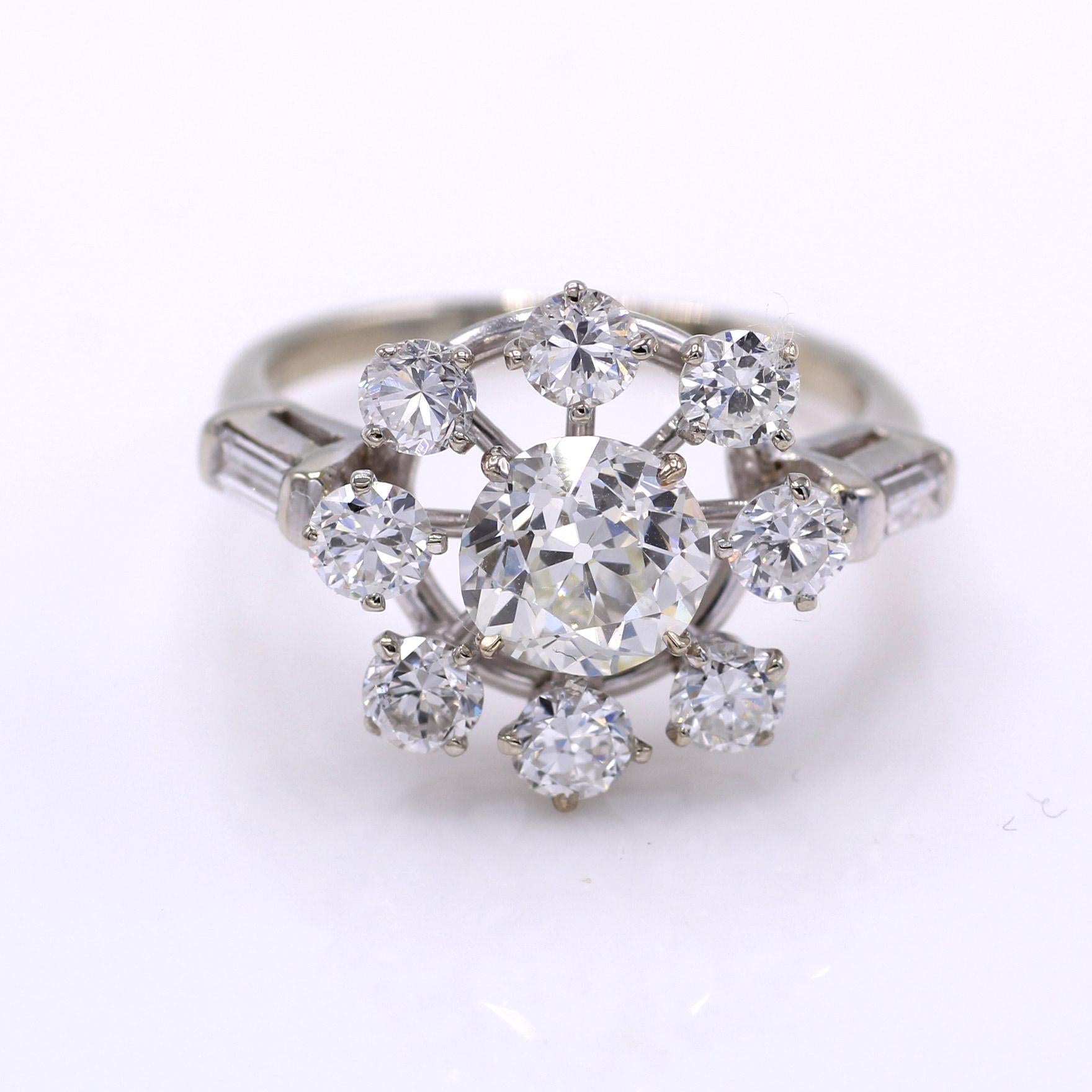 Centrally set in platinum this ring features a beautiful Old European Cut diamond weighing 1.42 carats accompanied by a report from the GIA with a color grade of I and a clarity of VS 1. Surrounded by 8 perfectly matched bright white Old European