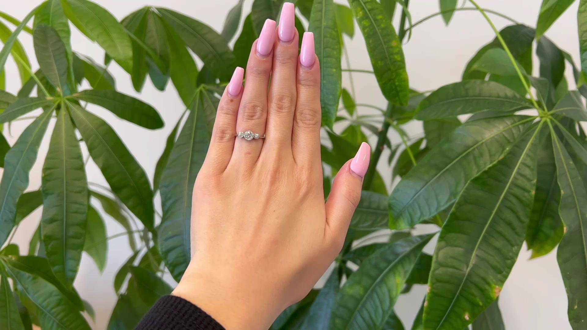One Art Deco Old European Cut Diamond Platinum Three Stone Ring. Featuring one old European cut diamond weighing approximately 0.50 carat, graded G color, VS clarity. Accented by two old European cut diamonds with a total weight of approximately