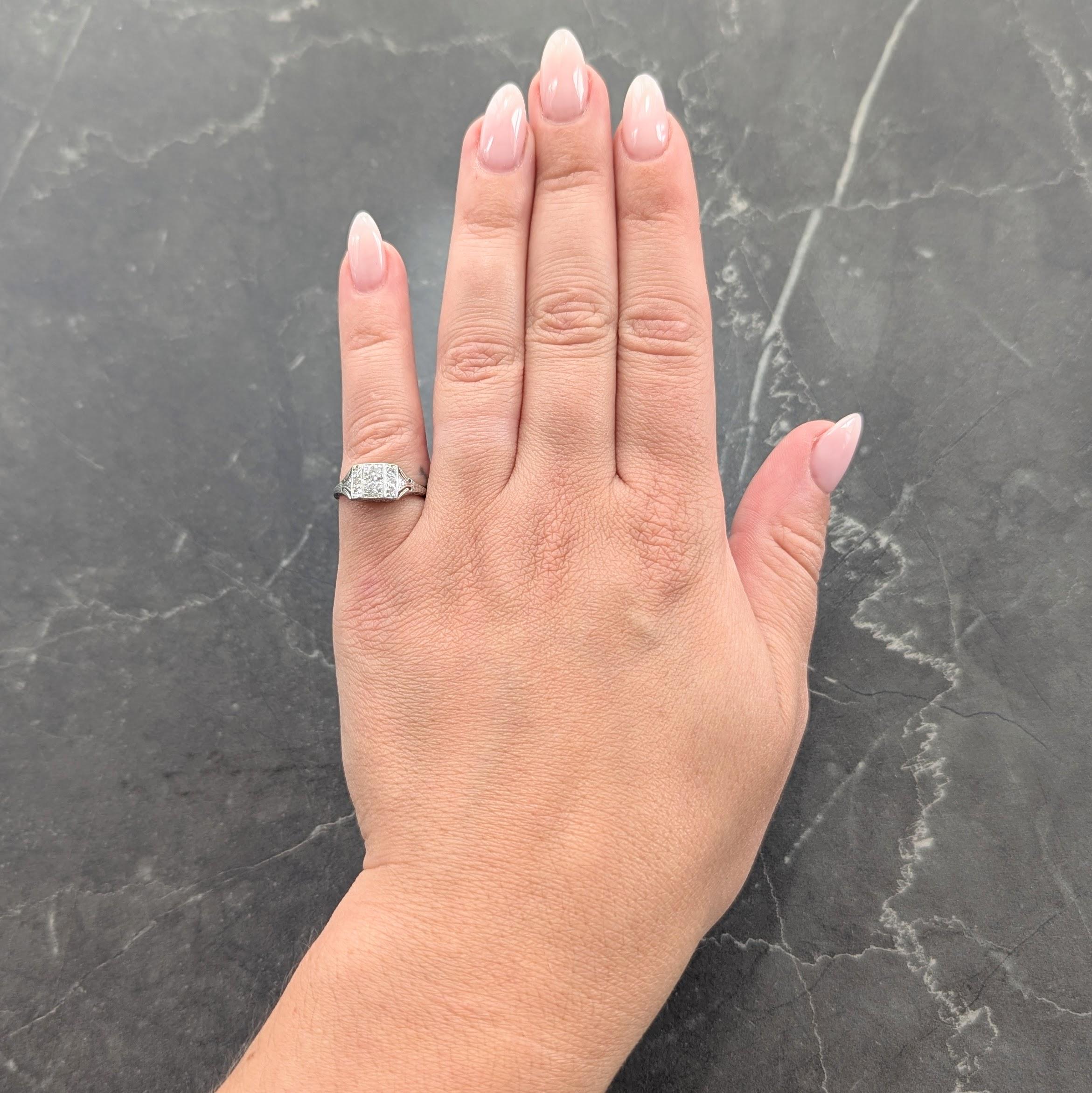 Centering two old European cut diamonds bead set north to south
Weighing approximately 0.24 carat total - H color with VS2 clarity
Flanked by rows of additional bead set diamonds
Weighing approximately 0.18 carat total - eye clean and
