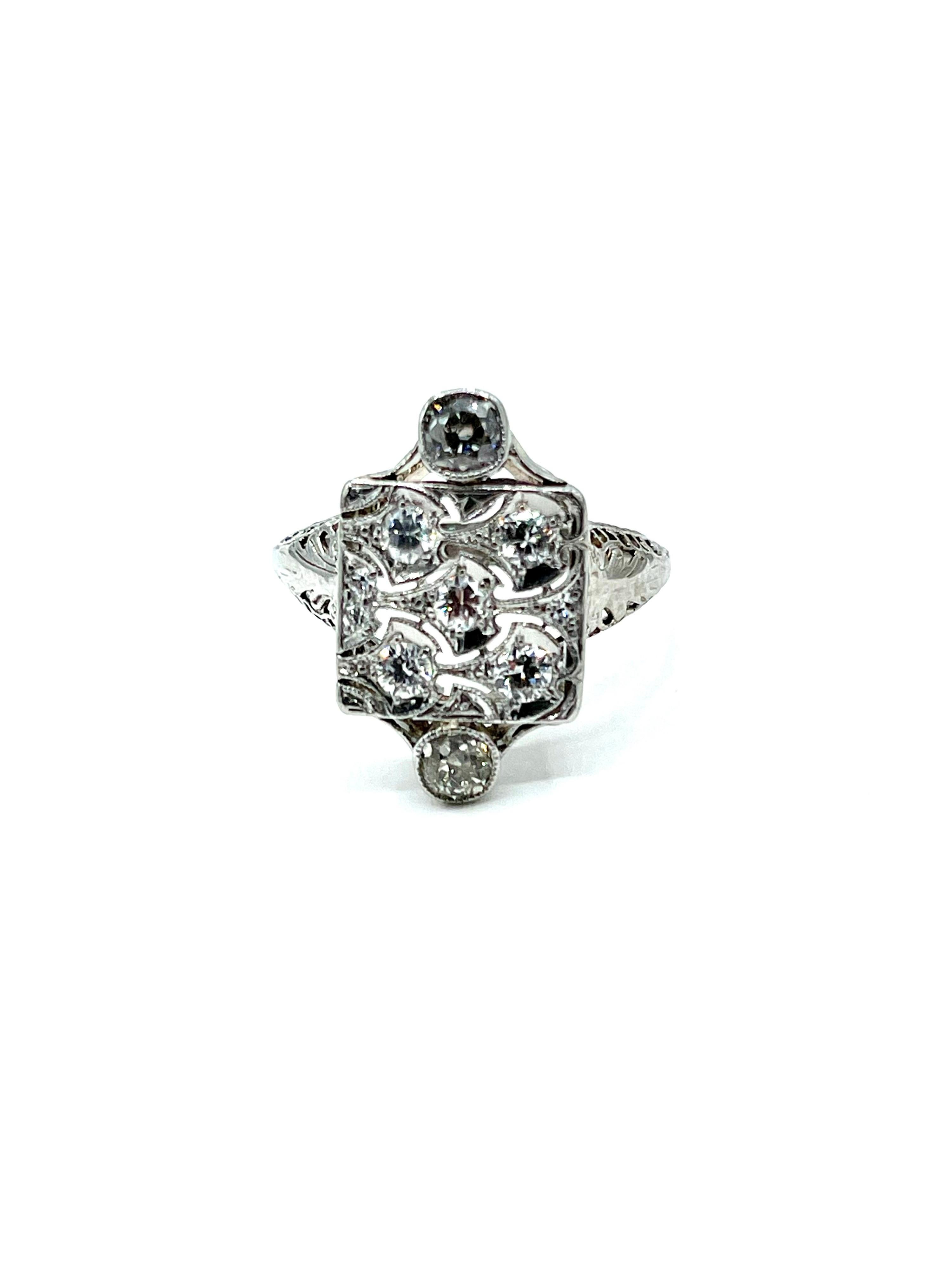 A beautiful Art Deco era cocktail ring!  The ring is made with nine old European cut Diamonds set in an open metal work flat top with two Diamond bezel set on the north and south of the ring.  The shank is a wide filigree that tapers in toward the