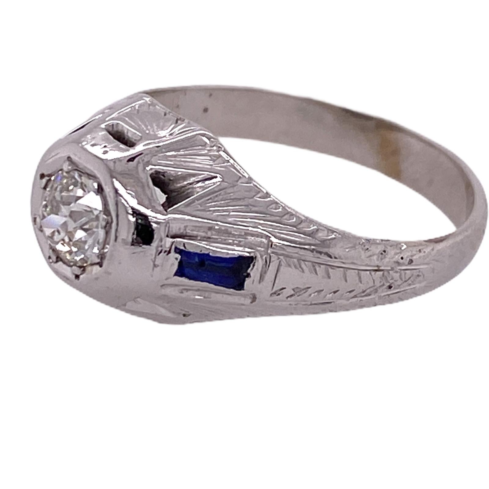 Beautiful Art Deco diamond ring fashioned in 18 karat white gold. The Old European Cut Diamond weighs approximately .50 carat and is graded I color and SI2 clarity. The mounting features sapphire accents and measures 11mm in width. The ring is