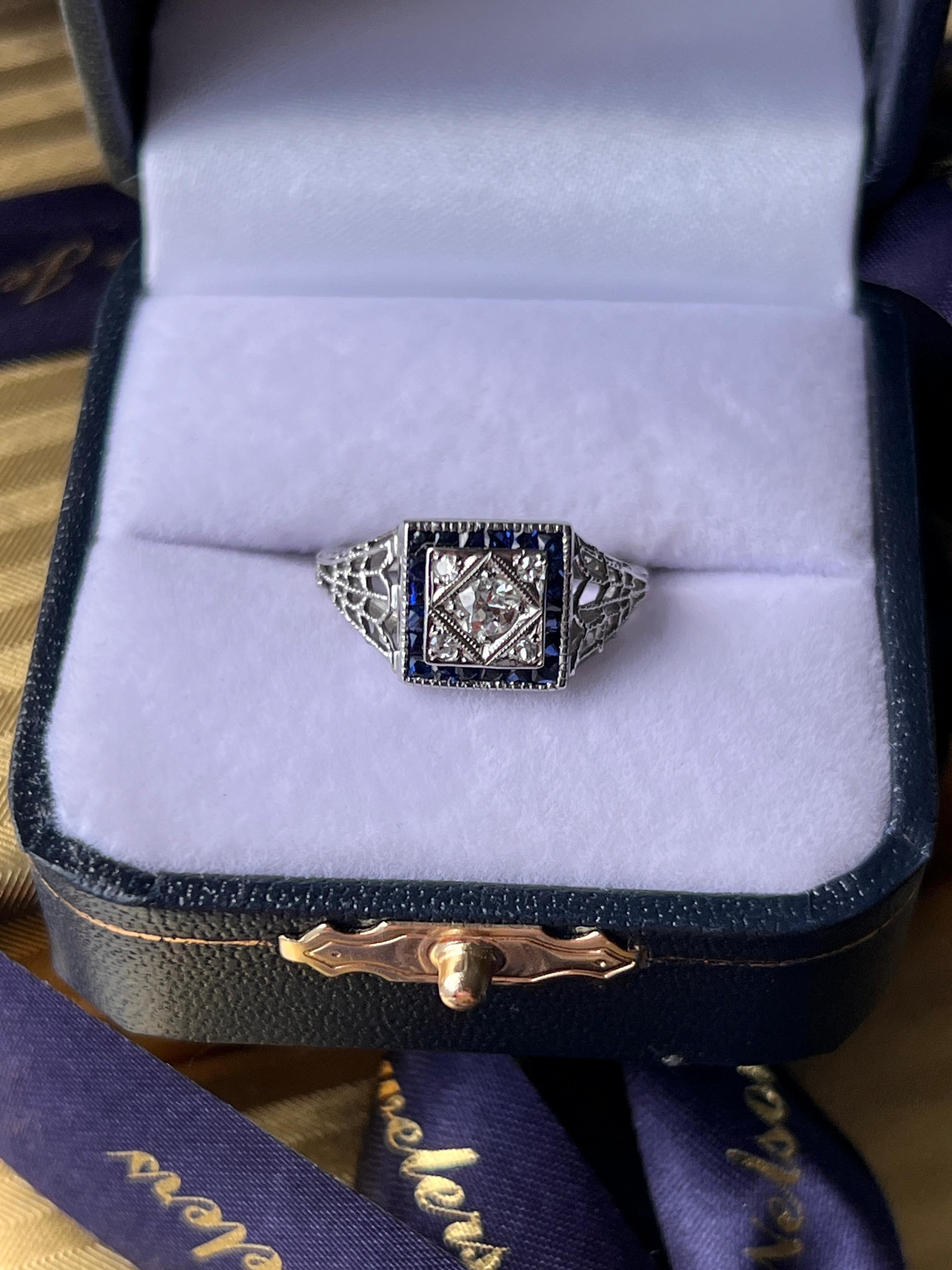An exquisite Art Deco 18 karat white gold filigree ring, crafted with intricate openwork detailing characteristic of the period. At the center glitters one Old European cut diamond weighing approximately 0.19 carat, with H color and I1 clarity,