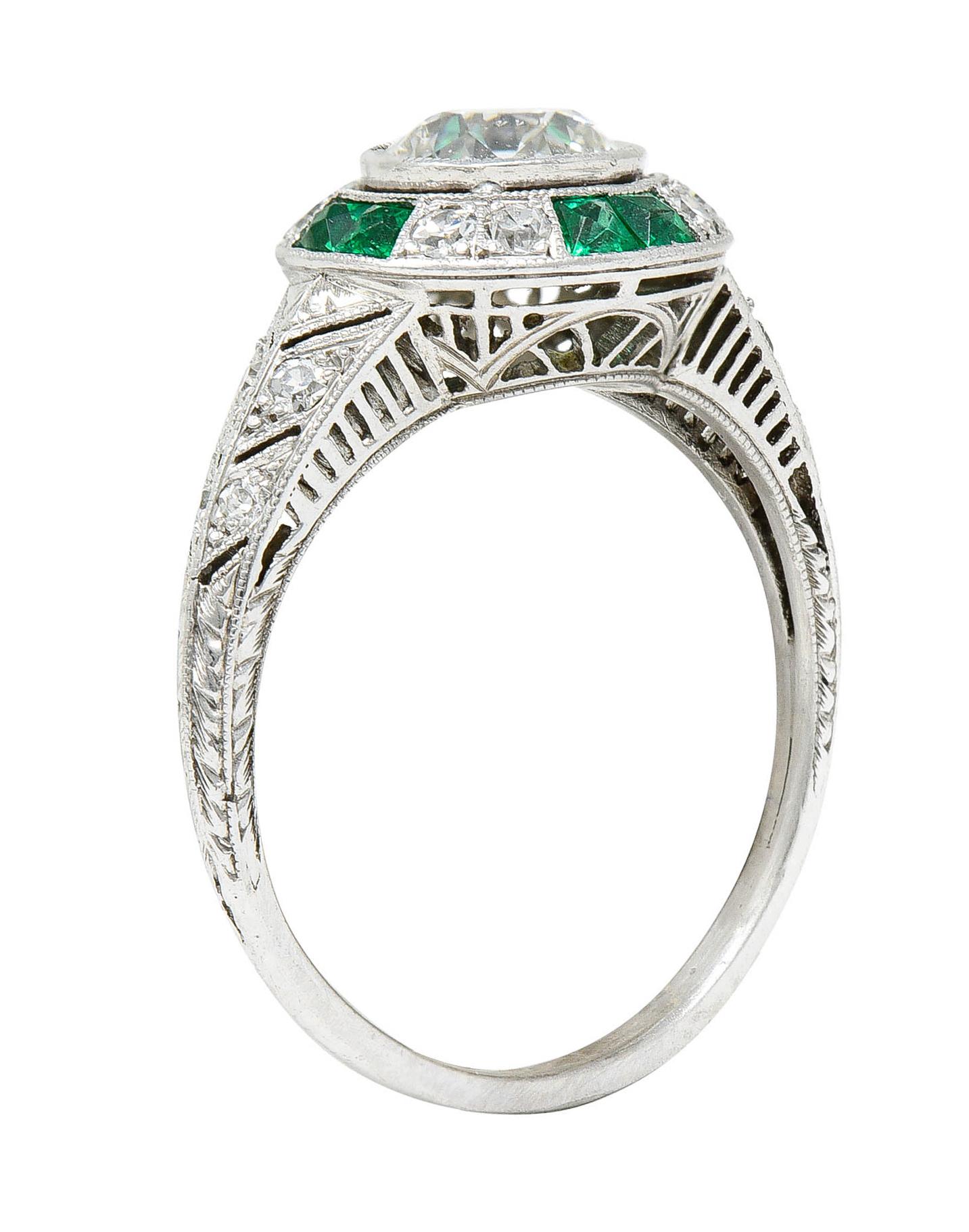 Centering an old European cut diamond weighing approximately 0.80 carat - H color with VS2 clarity

Bezel set with a diamond and emerald circular halo surround

French cut emeralds are bright green and well matched while weighing in total