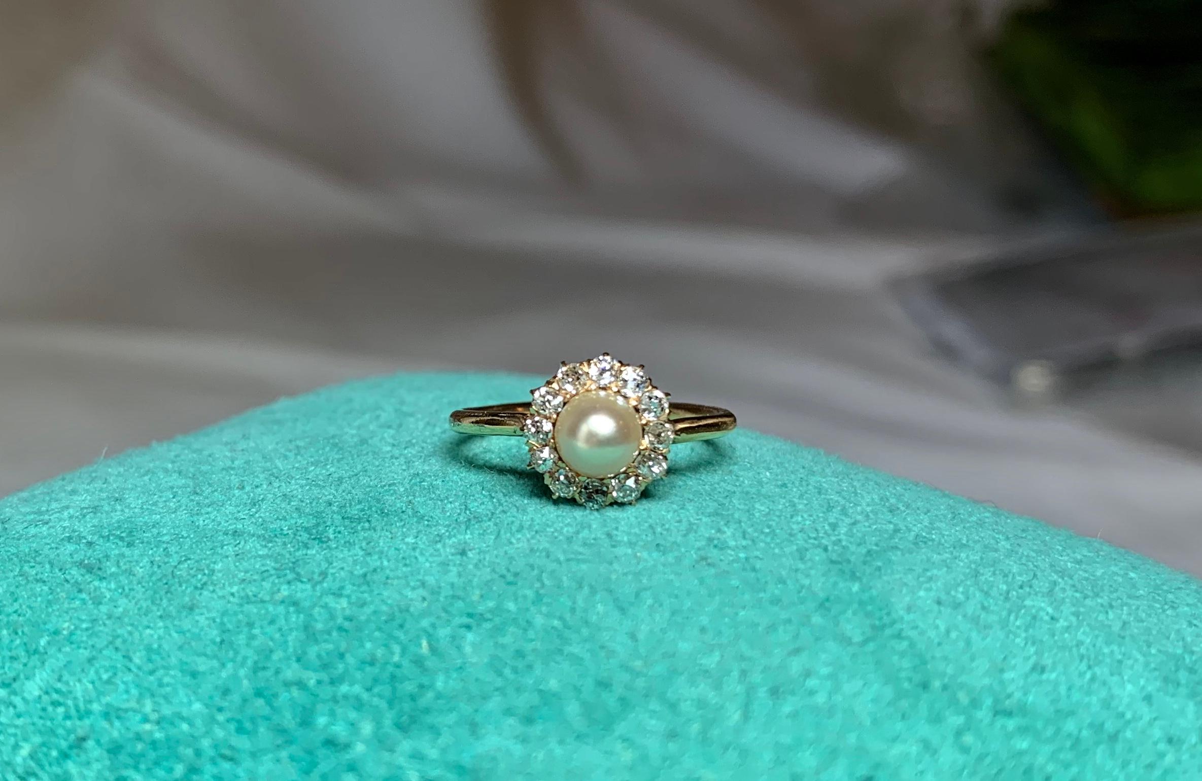 An stunning Antique Victorian - Art Deco Ring with a gorgeous Pearl of incredible color and stunning beauty.  The Pearl is surrounded by a halo of 12 brilliant sparkling antique Old European Cut Diamonds.  These diamonds are absolutely gorgeous.