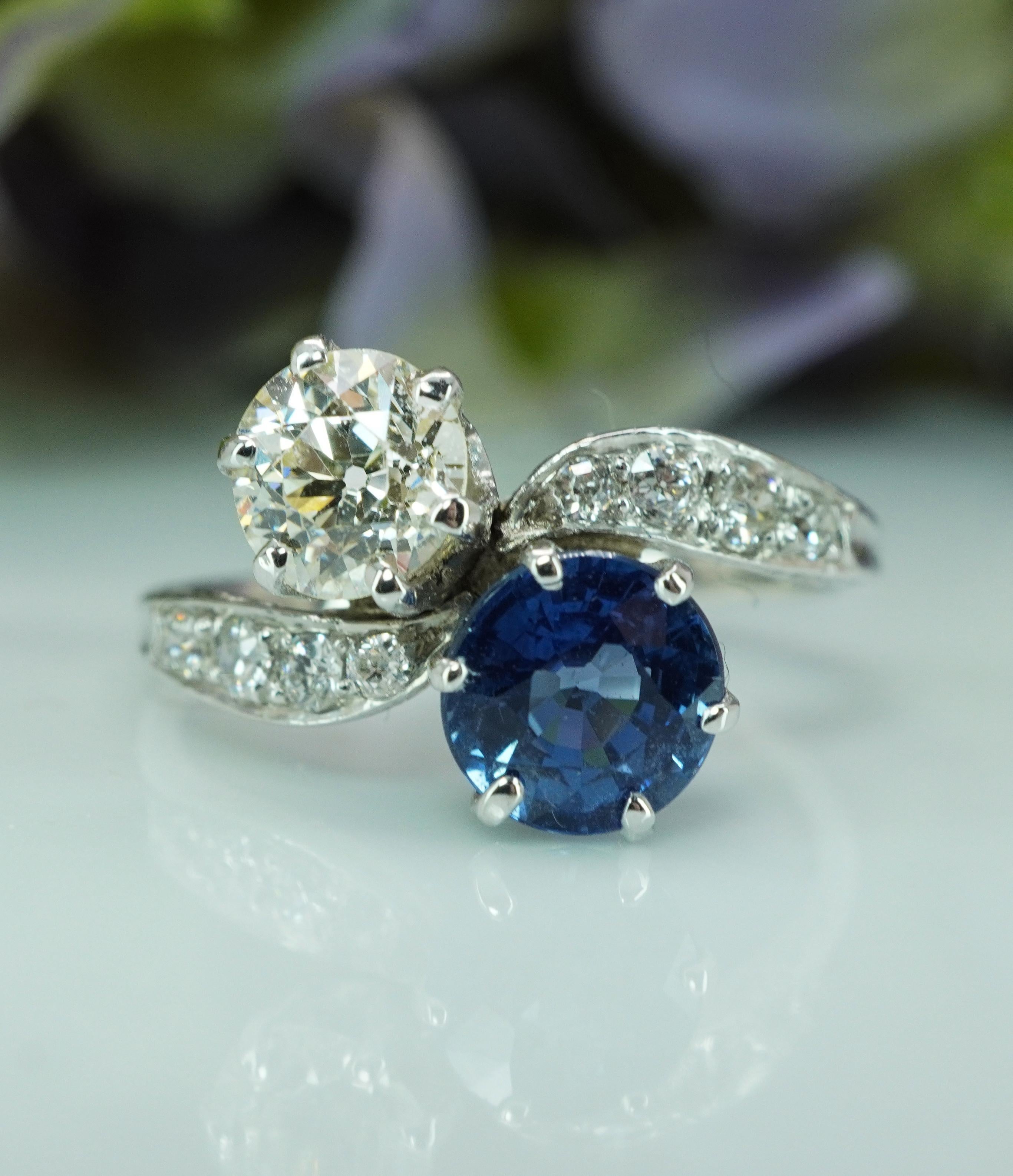  Art Deco Old European Diamond Sapphire Ring Platinum Antique Toi et Moi 

This totally stunning estate Art DECO platinum Toi et Moi piece holds a genuine earth mined round cut sapphire and old European cut diamond set in a bypass design. The center