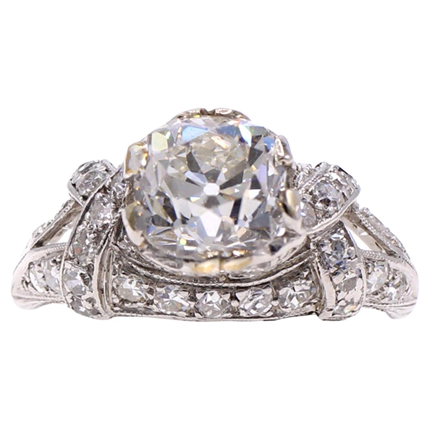 Beautifully designed and masterfully handcrafted Art Deco diamond platinum engagement ring from ca 1925. The center diamond is a beautifully cut Old Mine Brilliant cut diamond with incredible fire and life. The diamond weighs 2.01 carats and is