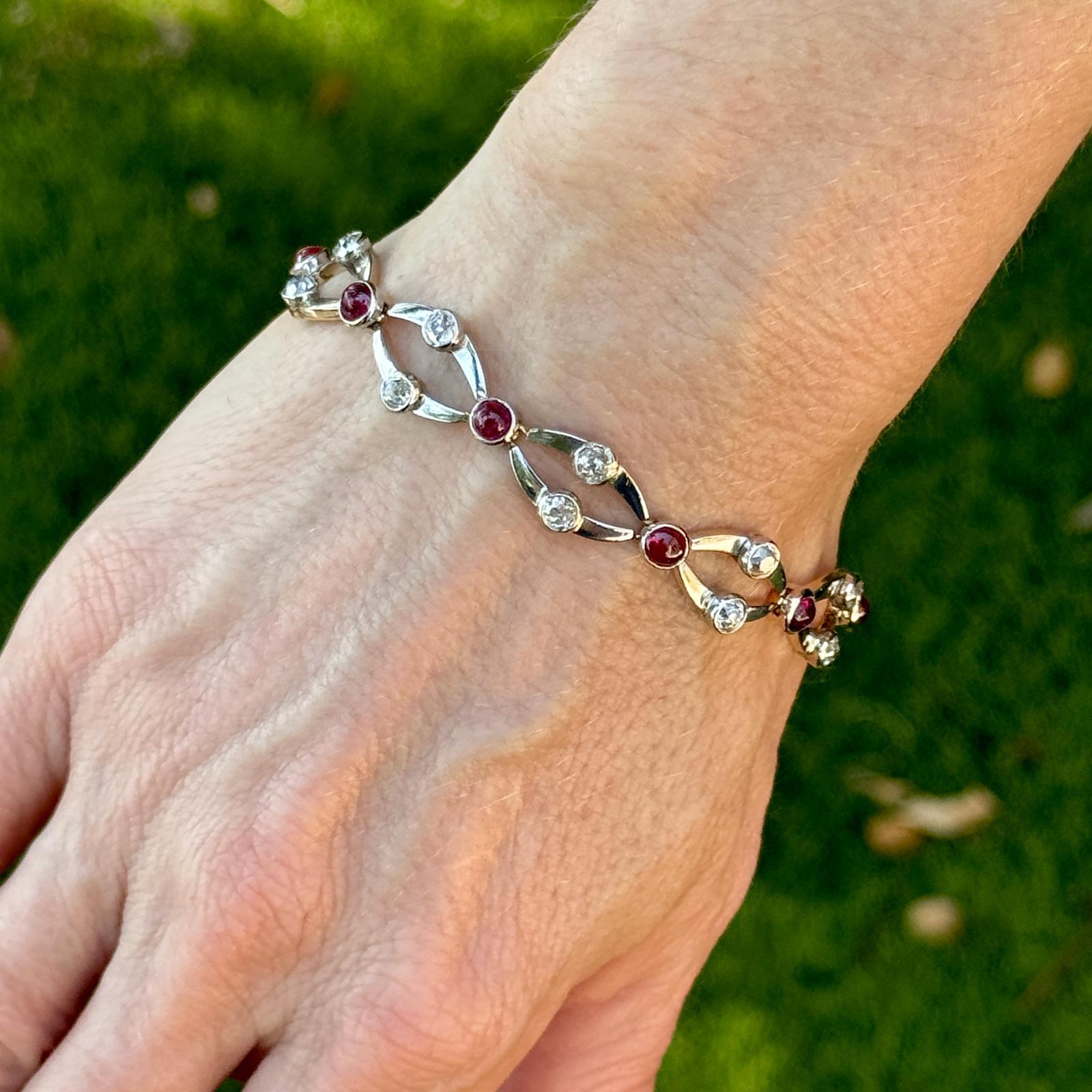 The Art Deco diamond ruby two-tone gold link bracelet is a stunning piece of jewelry that perfectly captures the glamour and sophistication of the Art Deco era. The bracelet features a captivating array of old mine cut diamonds and cabochon rubies,