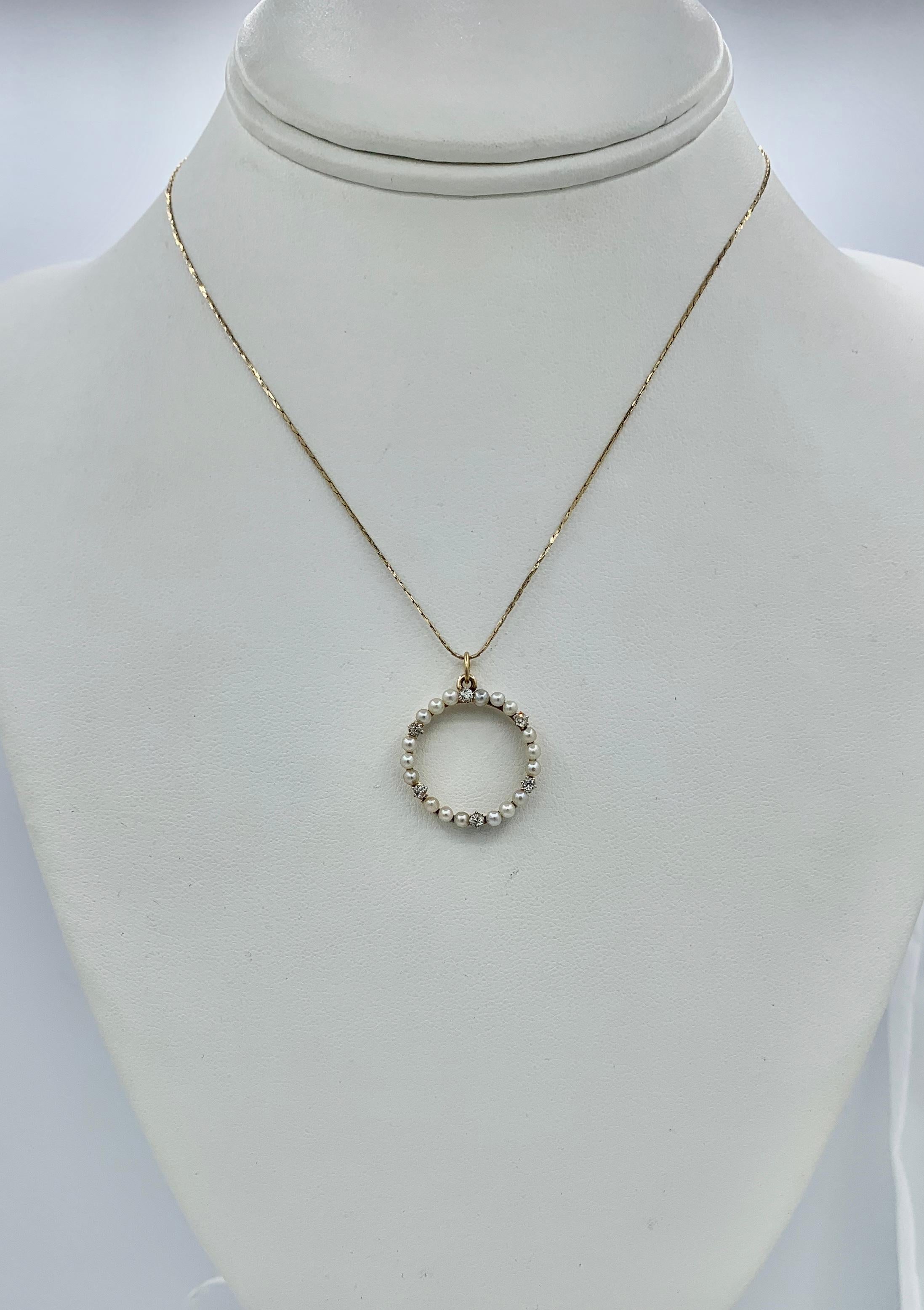 This is a beautiful antique Old Mine Cut Diamond and Pearl Victorian - Art Deco Circle Pendant.  The pendant is set with six Old Mine Cut Diamonds of lovely quality. The diamonds alternate with sets of three silvery white pearls.  The diamonds and