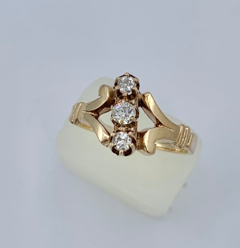 This is a stunning Antique Edwardian - Art Deco Diamond Engagement Wedding Ring with 3 gorgeous white Old Mine Cut Diamonds set in a classic setting in 14 Karat Yellow Gold.  The central Old Mine Diamond is approximately .15 Carat in size and the