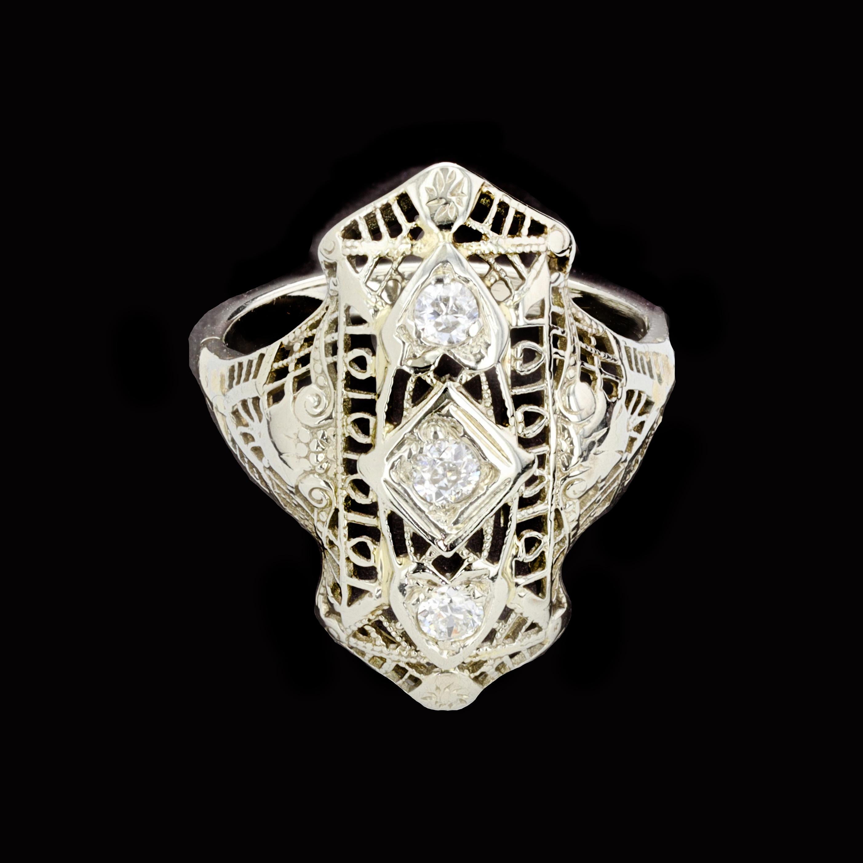 Amazing craftsmanship and intricate detail will have you falling in love over and over again with this vintage 18K white gold Art Deco diamond ring. Three round old mine cut diamonds 0.20ct., surrounded by delicate filigree star in this stunning