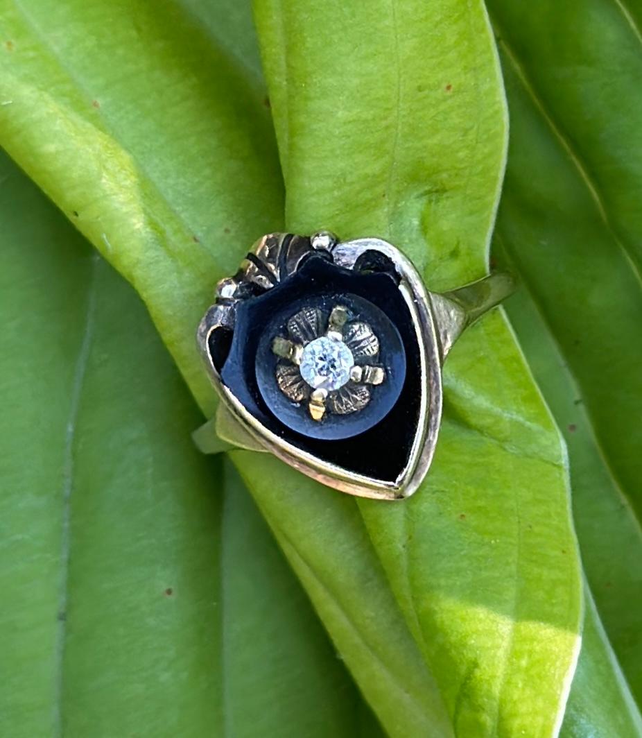 This is a very special Edwardian, Art Deco Heart Shape Ring with Black Onyx, a central Old Mine Cut Diamond and a wonderful shield design in 10 Karat Yellow Gold.  The antique ring has a beautiful shield form Black Onyx gem that is adorned with a