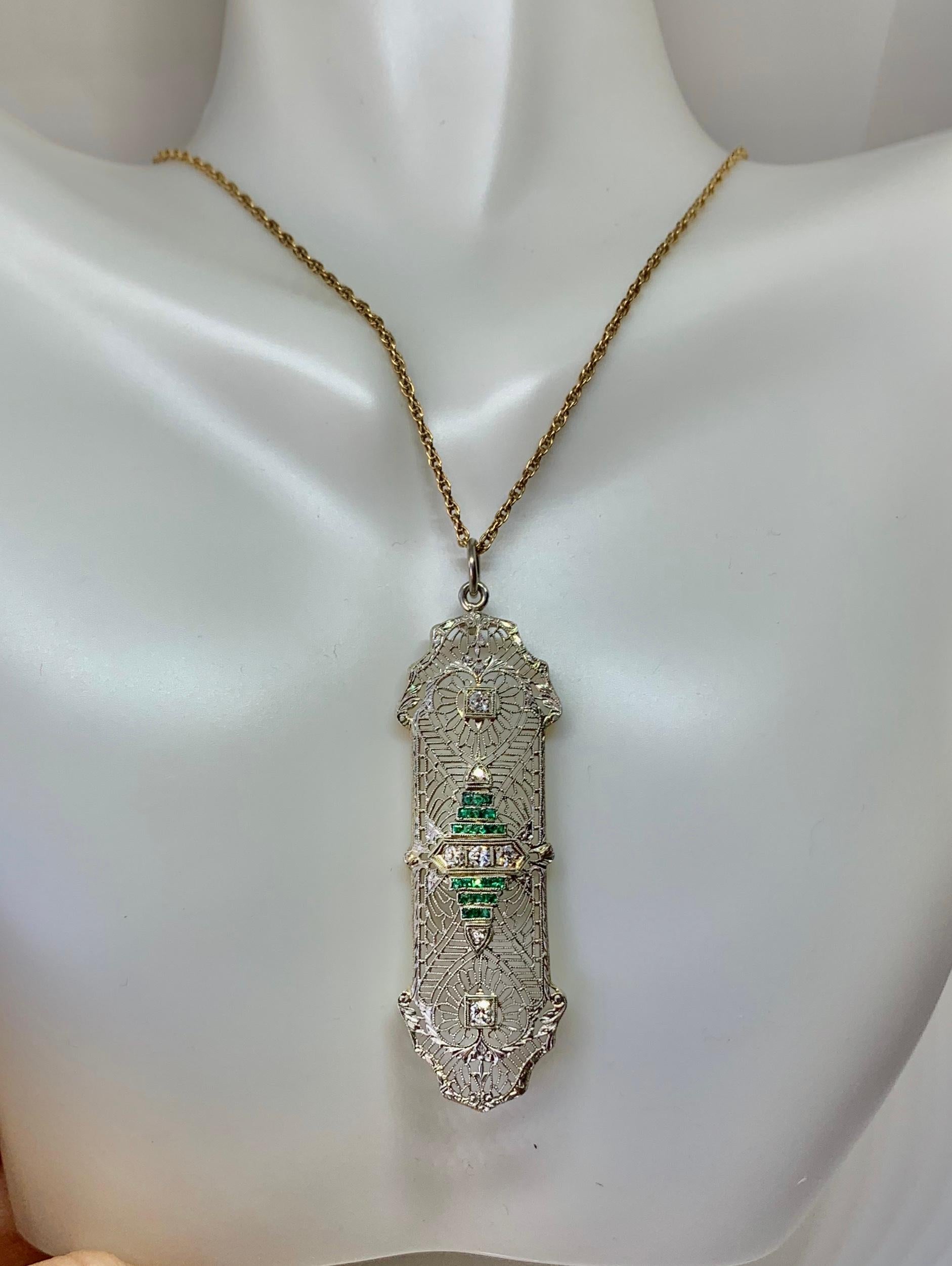 This is a very special antique Edwardian, Art Deco pendant with five sparkling Old Mine Cut Diamonds and 24 square cut Emeralds in an exquisite delicate refined filigree design in 14 Karat White Gold.  This is one of the most beautiful Art Deco