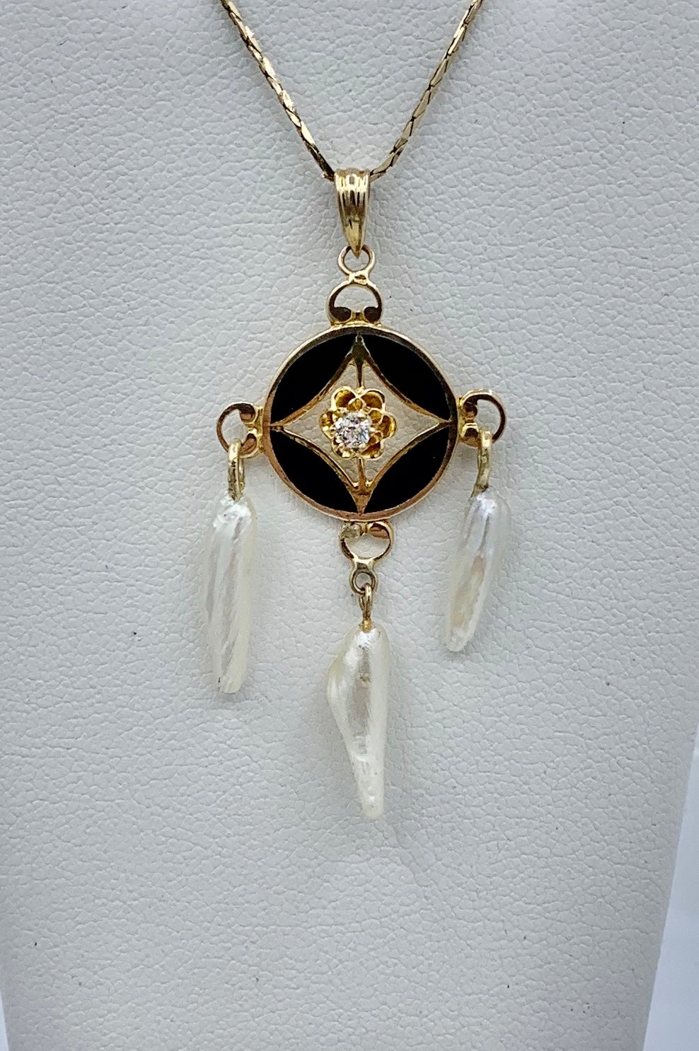 This is a beautiful antique Art Deco early 20th Century Old Mine Cut Diamond, Black Enamel and Pearl Pendant Lavaliere in 14 Karat Gold.  The exquisite pendant has delicate open work design, wonderful Art Deco styling, and beautiful gems.  In the