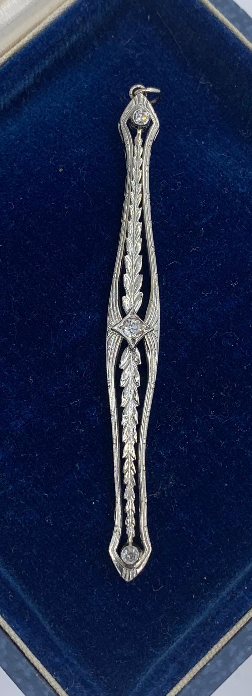 A very special antique Edwardian, Art Deco lavaliere pendant with three Old Mine Cut Diamonds in an open work leaf motif filigree design in 14 Karat White Gold.  In the center is a sparkling white Old Mine Cut Diamond of approximately 10 points. 