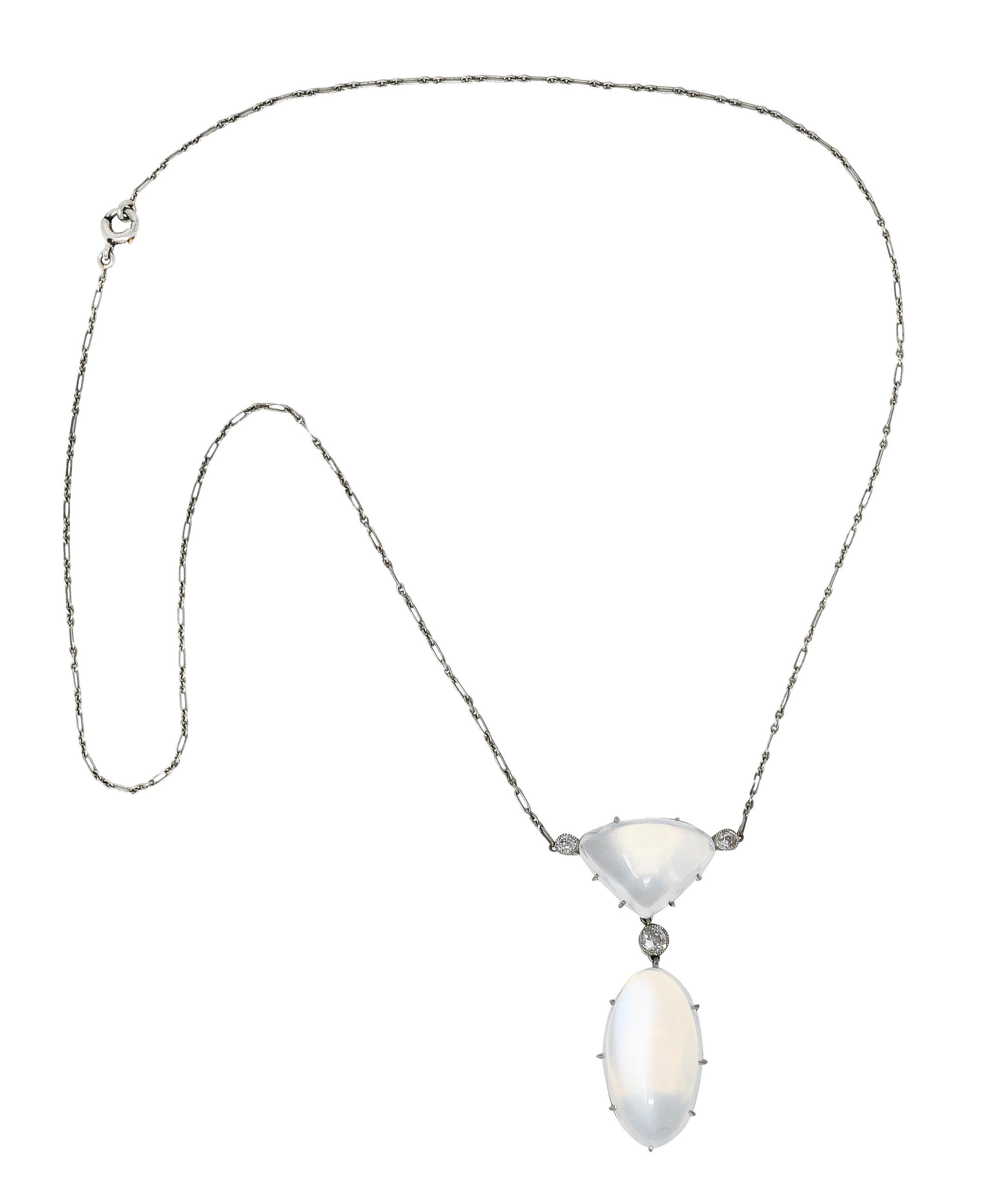 Necklace centers a triangular moonstone cabochon station suspending an oval moonstone drop. Prong set with pierced gallery - measuring 13.0 x 17.0 mm and 13.0 x 23.0 mm, respectively. Translucent white in body color with white adularescence and