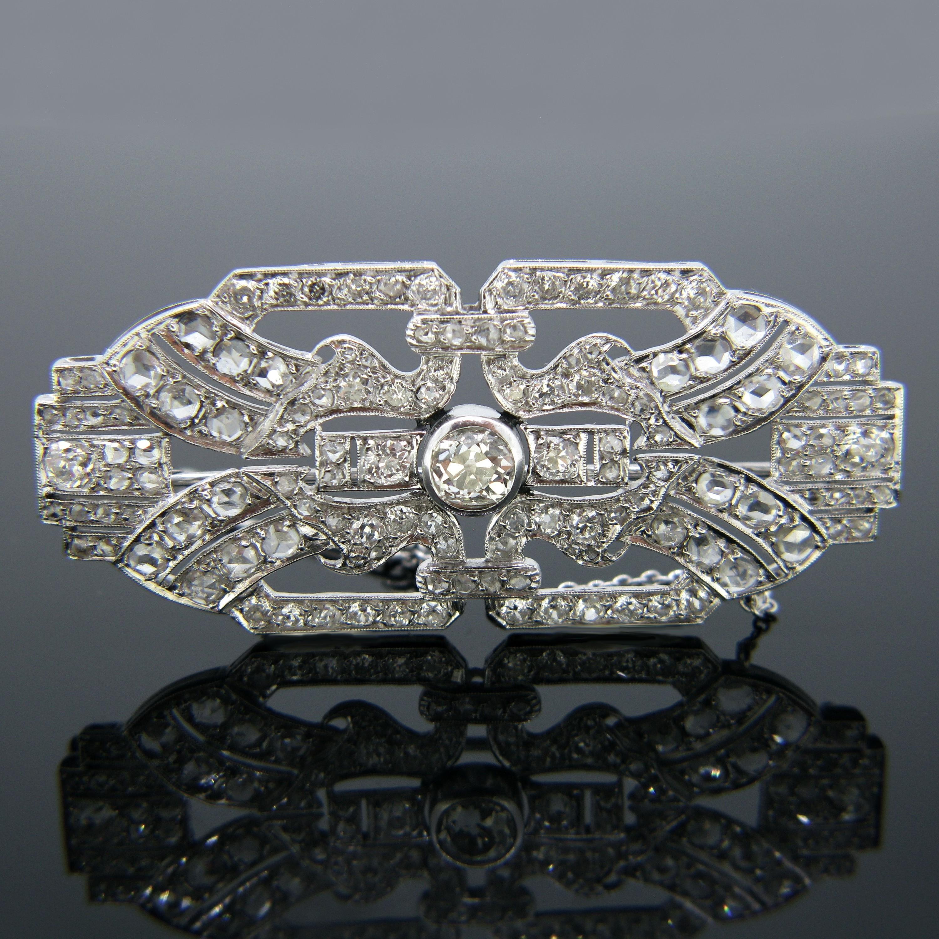 This brooch is from the Art Deco era and is made in platinum. It features 133 diamonds – 88 Rose Cut, 44 Old Mine arranged in a typical Art Deco design. In the centre it is set with an old mine cut diamond weighing approximately 0.80ct. It is a