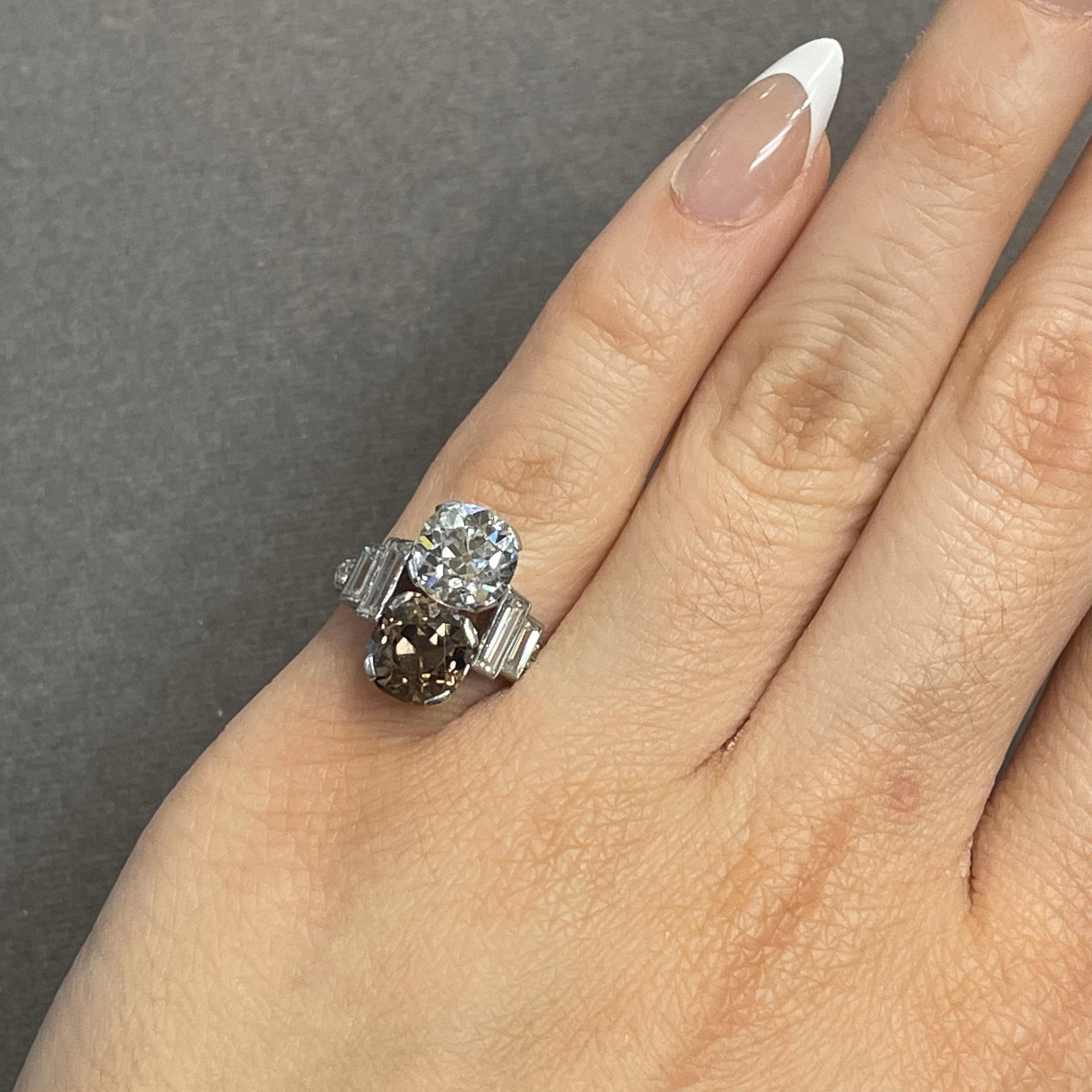 Art Deco Old Mine White & Champagne Diamond You and Me Ring

An Art Deco ring featuring a brown and a white old mine diamond, accented with baguette and round-cut diamonds on both sides.
The center two diamonds are approximately 1.75 carats