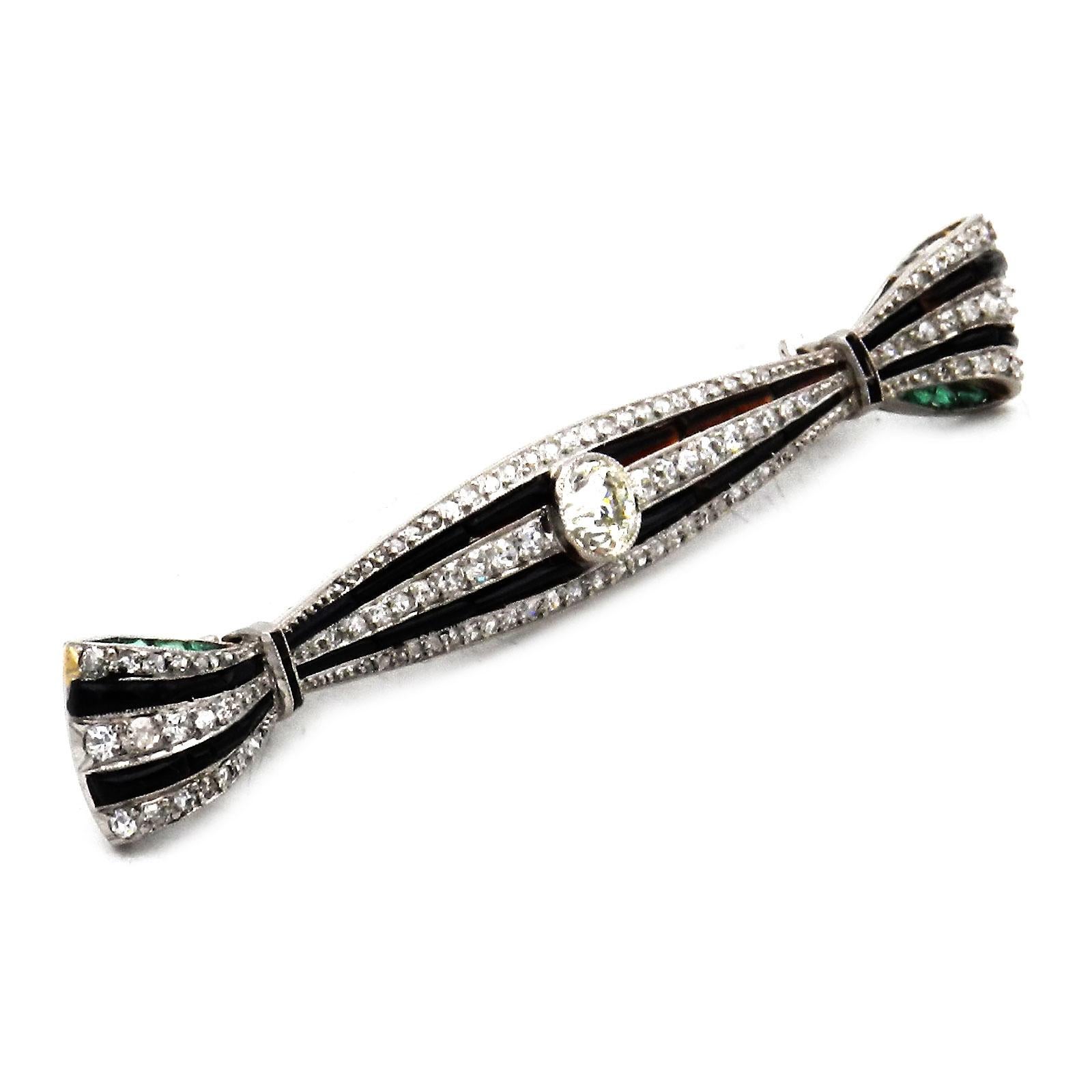 Art Deco Onyx 0.94 Carat Diamond Platinum Bow Brooch circa 1920

Decorative, very finely worked bar brooch in the form of an elongated bow, set in the center with a large old-cut diamond of 0.54 ct, J/vs, the lengths set with alternating onyx