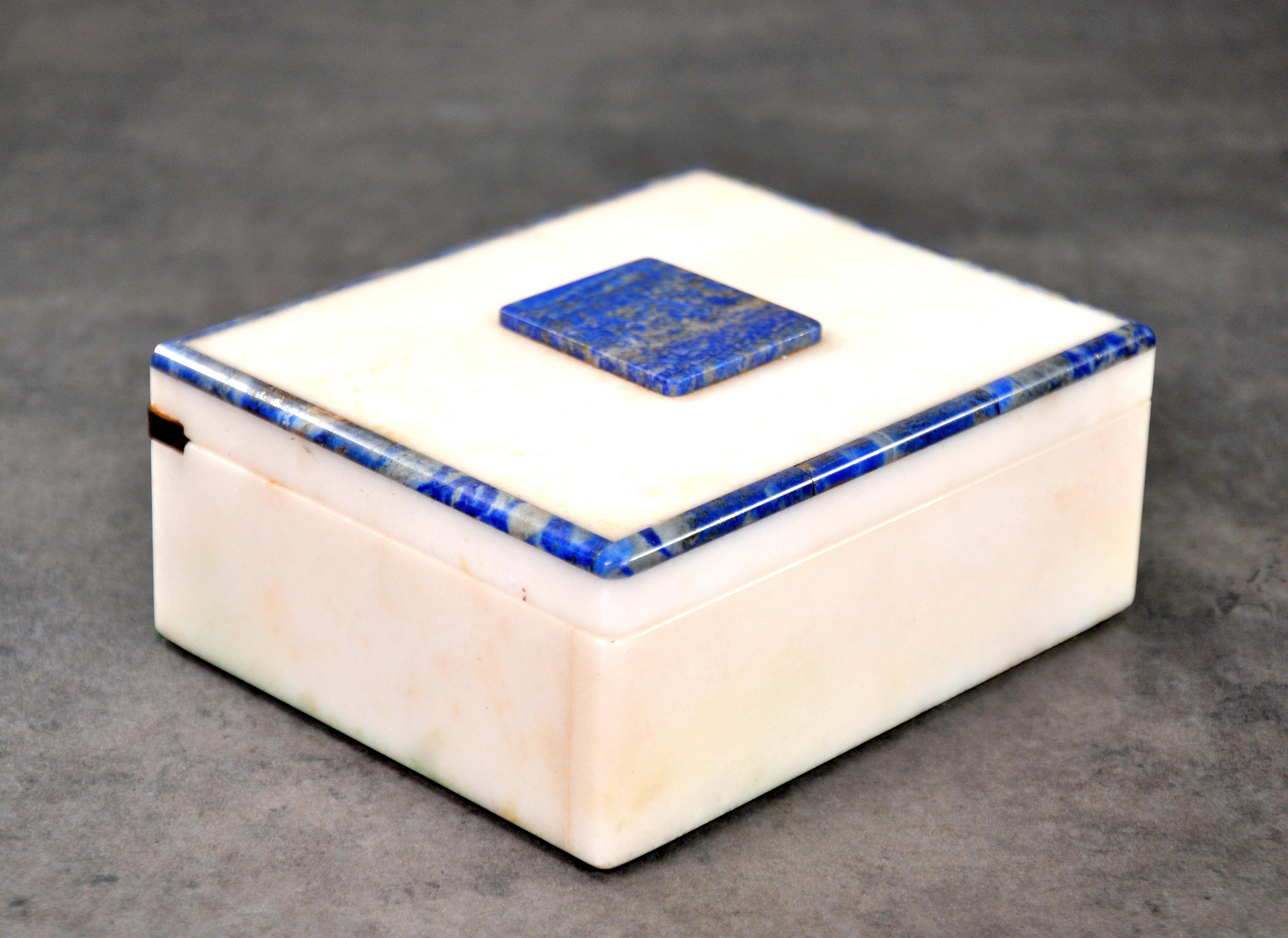 An Art Deco rectangular white onyx and lapis lazuli trinket, jewelry or vanity box with brass piano hinged lid.