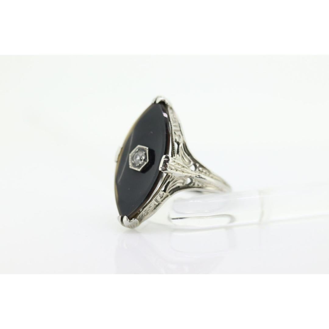 Vintage from the 1950s
Size: 5 1/2 US
Materials: Platinum
Gemstone: Onyx
Gem color: Black
Band color: Gold

Style: Art deco

Beautiful Art Deco ring made half of the century. Shows little wear.

14k Filigree White Gold Ring. Total weight 3.1
