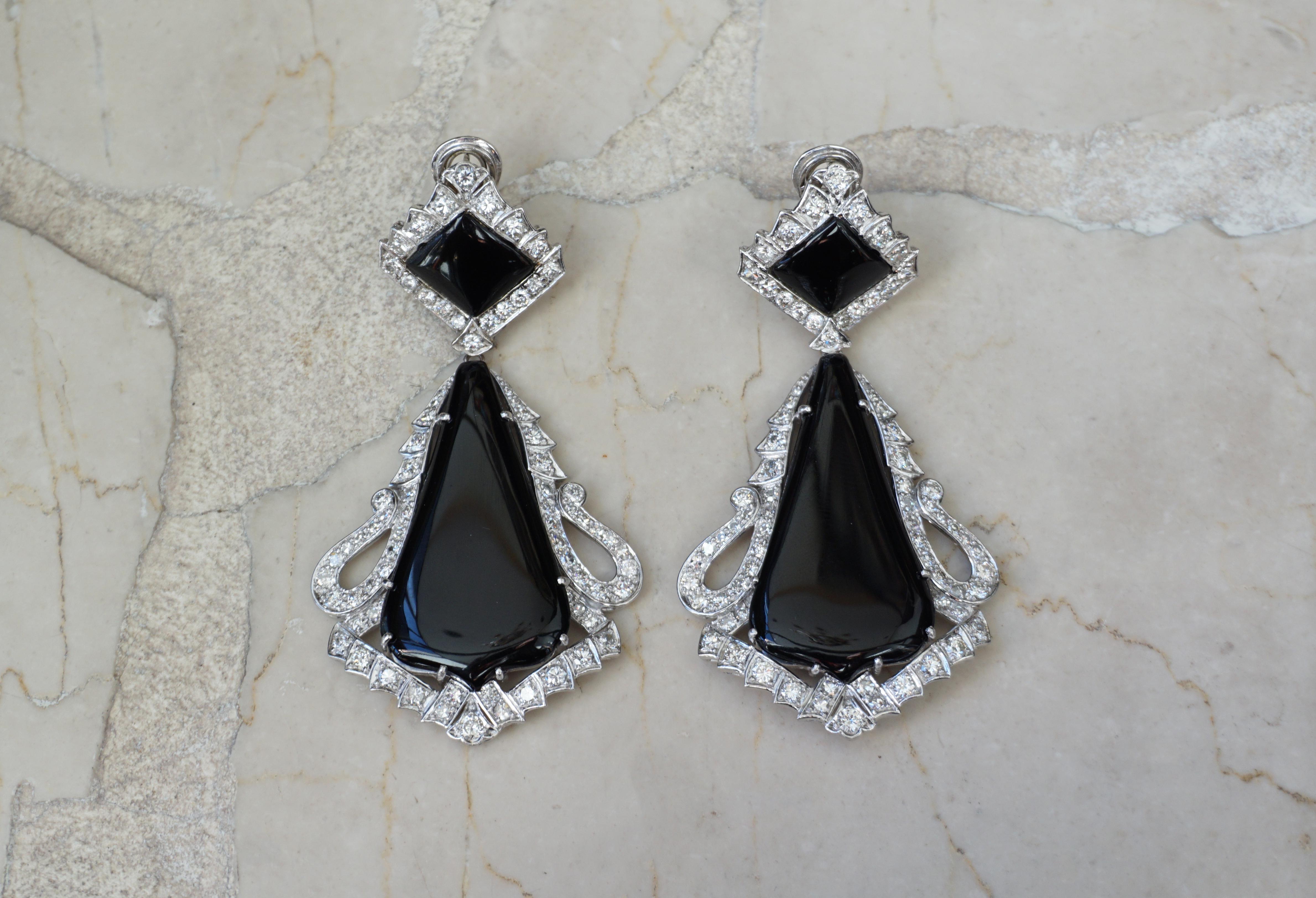 Vintage European Circa 1970

Constructed completely of 18 Karat White Gold
with detachable bottom Pendants

Containing 4 Custom-cut Polished pieces of Genuine Earth-Mined Black Onyx

& a total of approximately 5.50 carats of Colorless Genuine