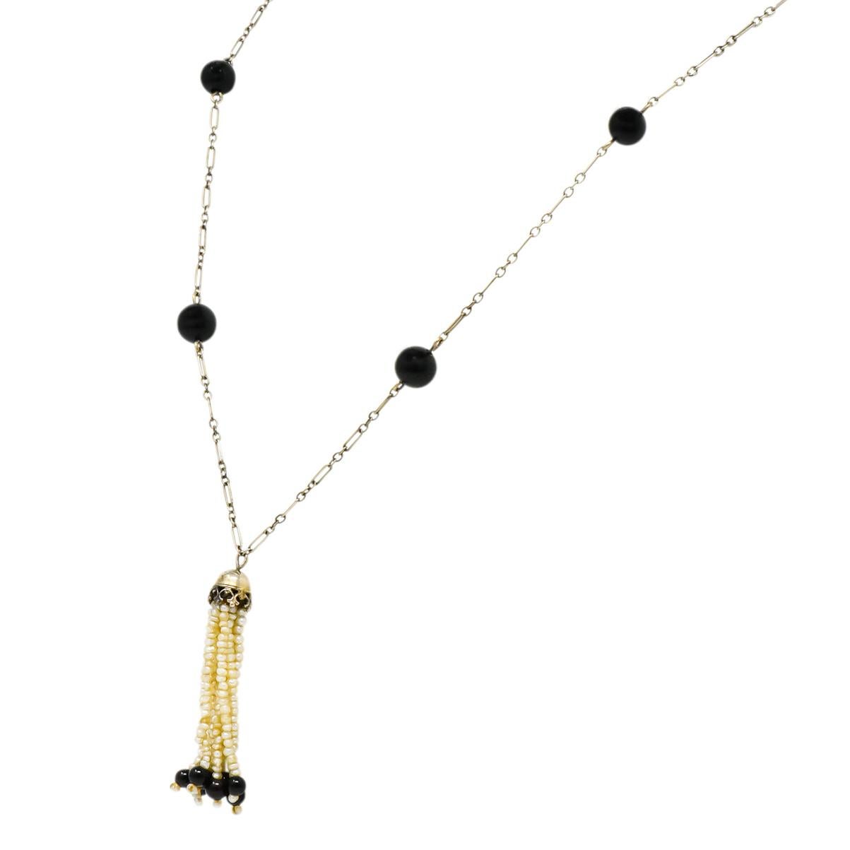 With ten seed pearl tassels, each terminating in a seed pearl and round onyx bead

With a polished millegrain and decorative cap

On a long and short cable style chain with graduated polished onyx bead stations

Twelve round onyx beads measure