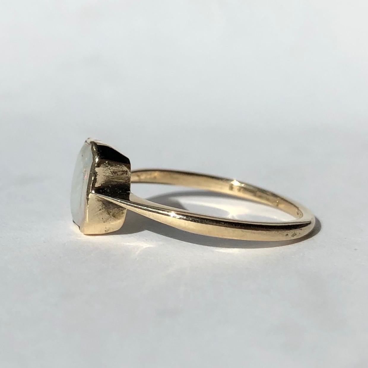 This ring has a classic Art Deco feel with the shape of the setting. The opal is pale but has bright flecks of colour running through. The setting and band is very simple and modelled in 18ct gold. 

Ring Size: M 1/2 or 6 1/2
Stone Dimensions: 8x6mm