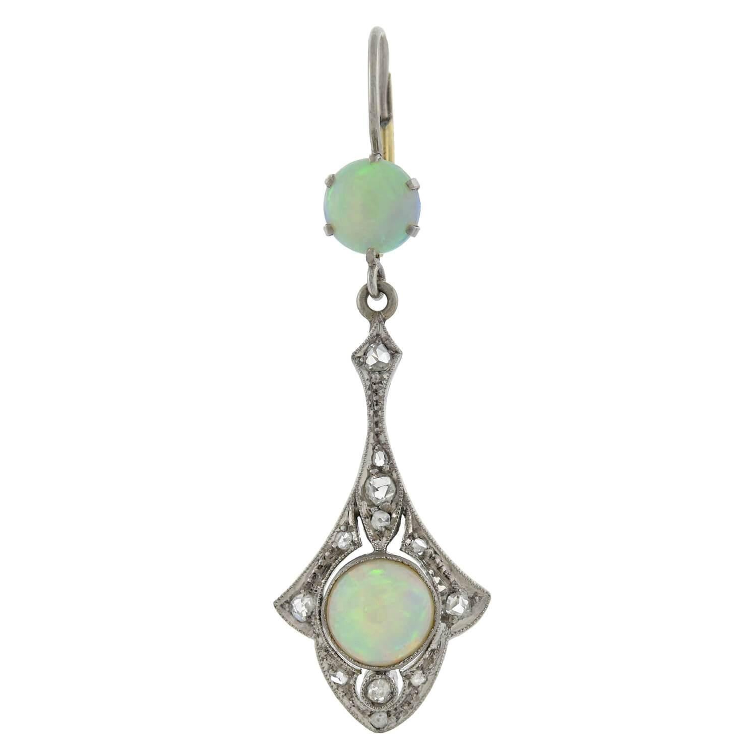 A gorgeous pair of opal earrings from the Art Deco (1920s) era! Crafted in 14kt white gold, each earring features two vibrant opals and an array of sparkling old Rose Cut diamonds. The earrings dangle from 14kt white and yellow gold lever back wires