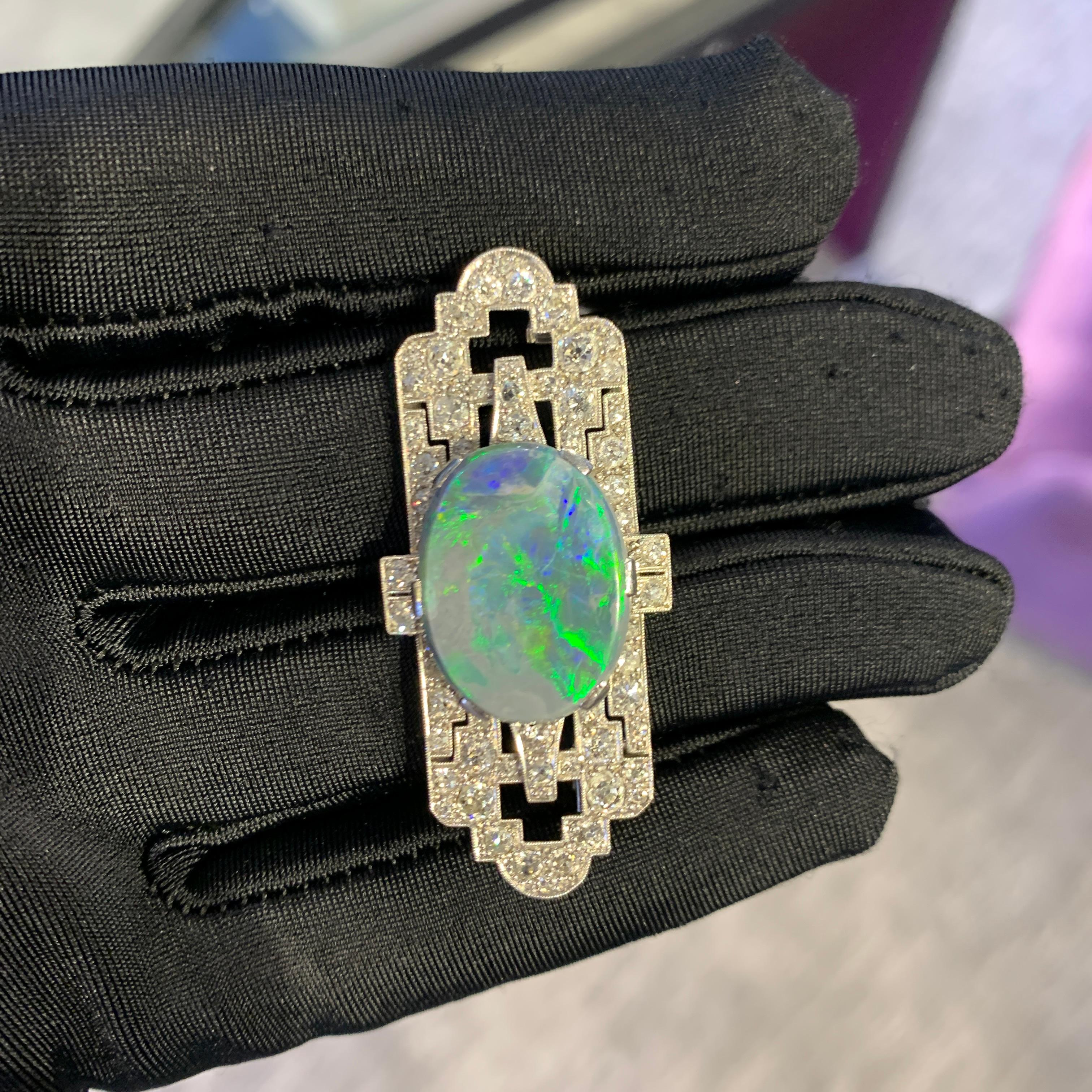 Art Deco Opal & Diamond Brooch

A platinum and 18 karat white gold brooch set with a center black opal weighing approximately 7.75 carats framed by approximately 3.35 carats of round cut diamonds

Measurements: 1.88