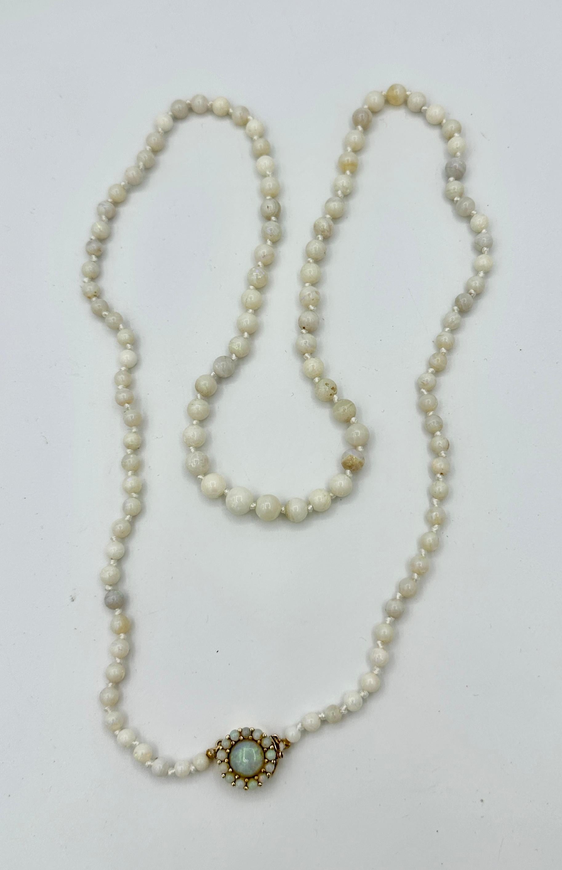 INDULGE IN THIS RARE ART DECO OPAL AND 14 KARAT GOLD NECKLACE.  THE EXTRAORDINARY JEWEL HAS THE MOST STUNNING NATURAL MINED ROUND OPAL BEADS THAT ARE GRADUATED FROM 4MM TO 8MM.  THE NECKLACE IS 31 INCHES LONG.  IT HAS A MAGNIFICENT CLASP SET WITH A