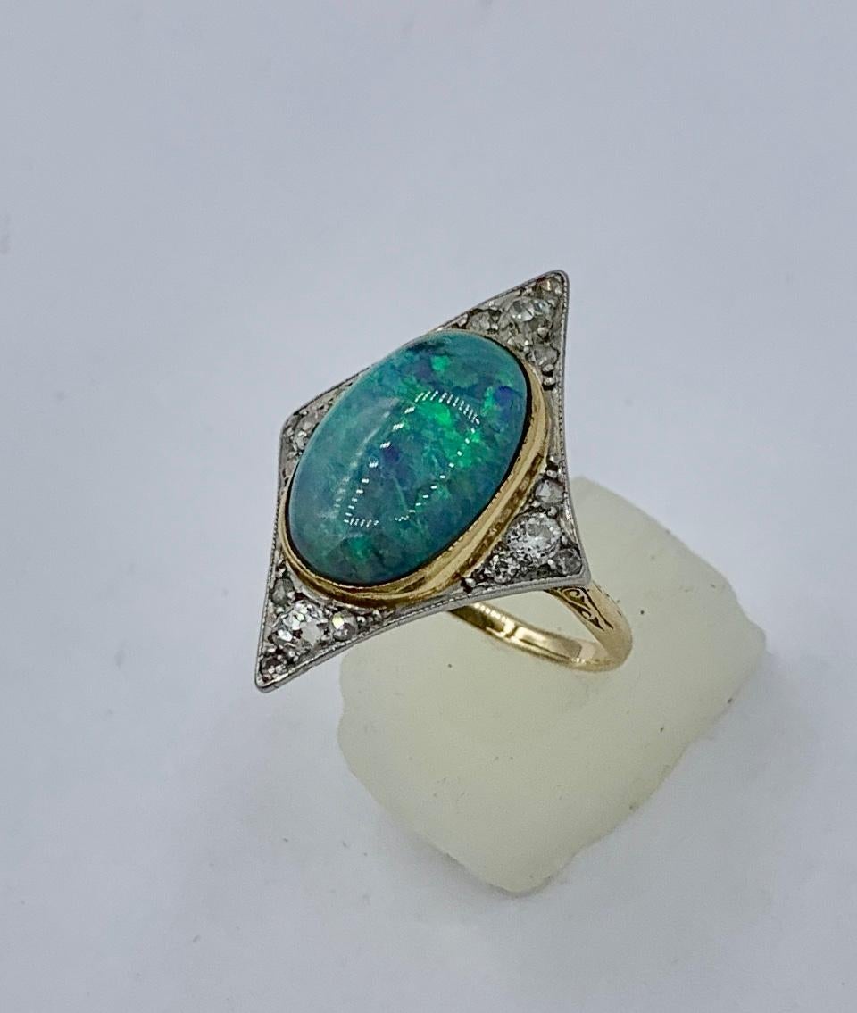 This is one of the most beautiful Antique Victorian - Art Deco Opal Diamond Platinum Rings we have seen.  The extraordinary opal has rich blues and greens of great beauty.  The opal is an oval cabochon of approximately 2.40 Carats.  The exquisite