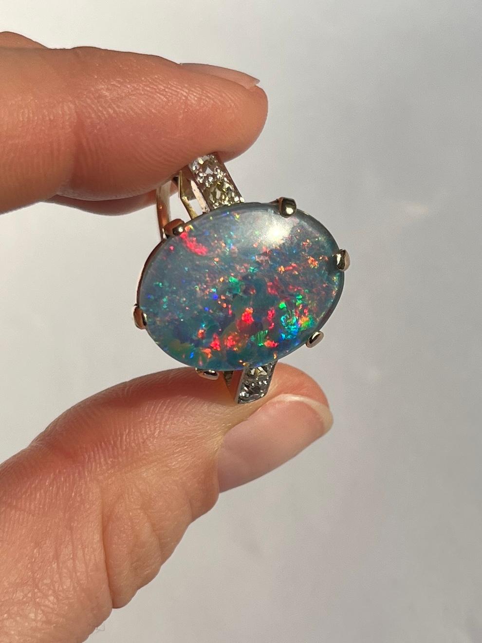 This ring is a show stopper! The colours of this opal triplet are beautiful. The stone has pairs of sparkling diamonds sat either side which total 40pts. The ring is modelled in 18 Carat yellow gold and diamond set in platinum. 

Ring Size: M 1/2 or