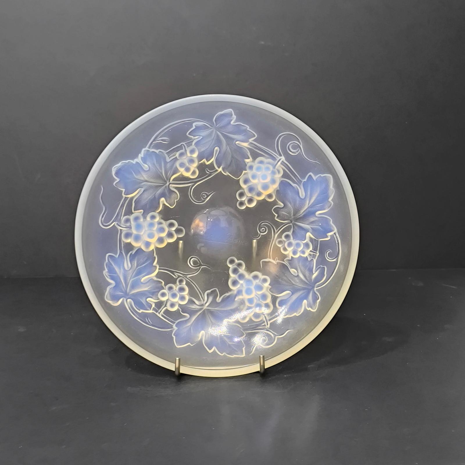 Art-deco opalescent bowl. Sculpted opalescent press glass round, with the decor of grapes and vine leaves. Resting on 3 feet formed from the bigger grapes.  In the center, a relief molded signature: Cesari France. 
Excellent condition. 
Diameter 20