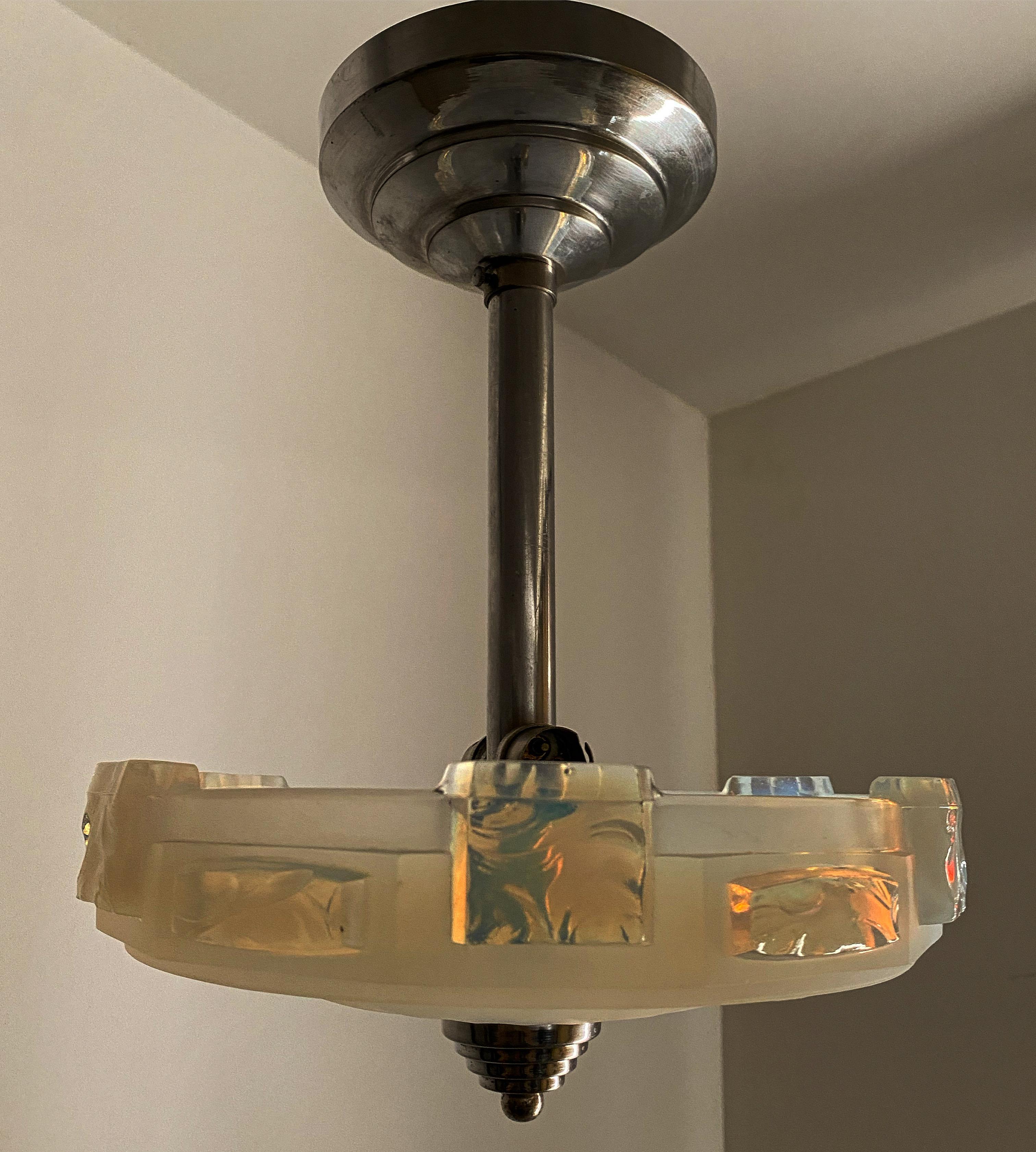 Small pendant light manufactured in France circa 1940. 
It takes 2 bayonette bulbs. 
No signature is present but the style points to Ezan and it is comparable to the works of Petitot, Rene Lalique and many other Art Deco glass manufacturers.
